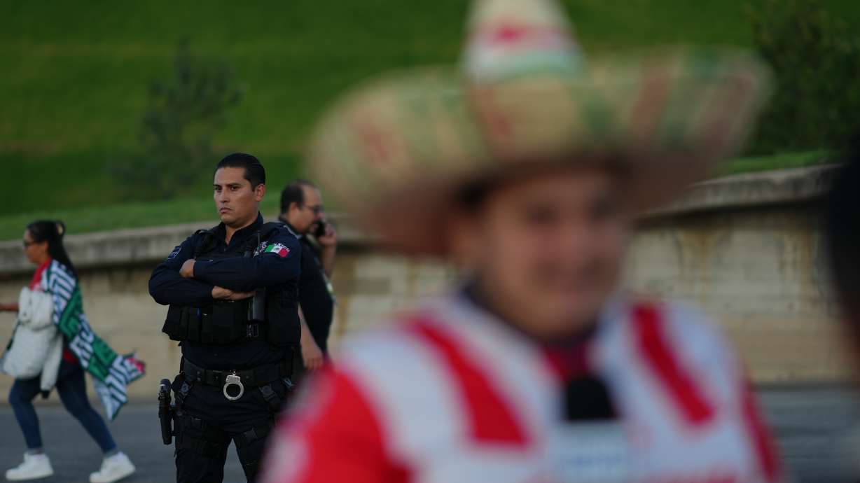 A police officer stands guard outside Akron Stadium prior to a friendly match between Mexico and Ecuador in Guadalajara, Mexico, Tuesday, Oct. 14, 2025.