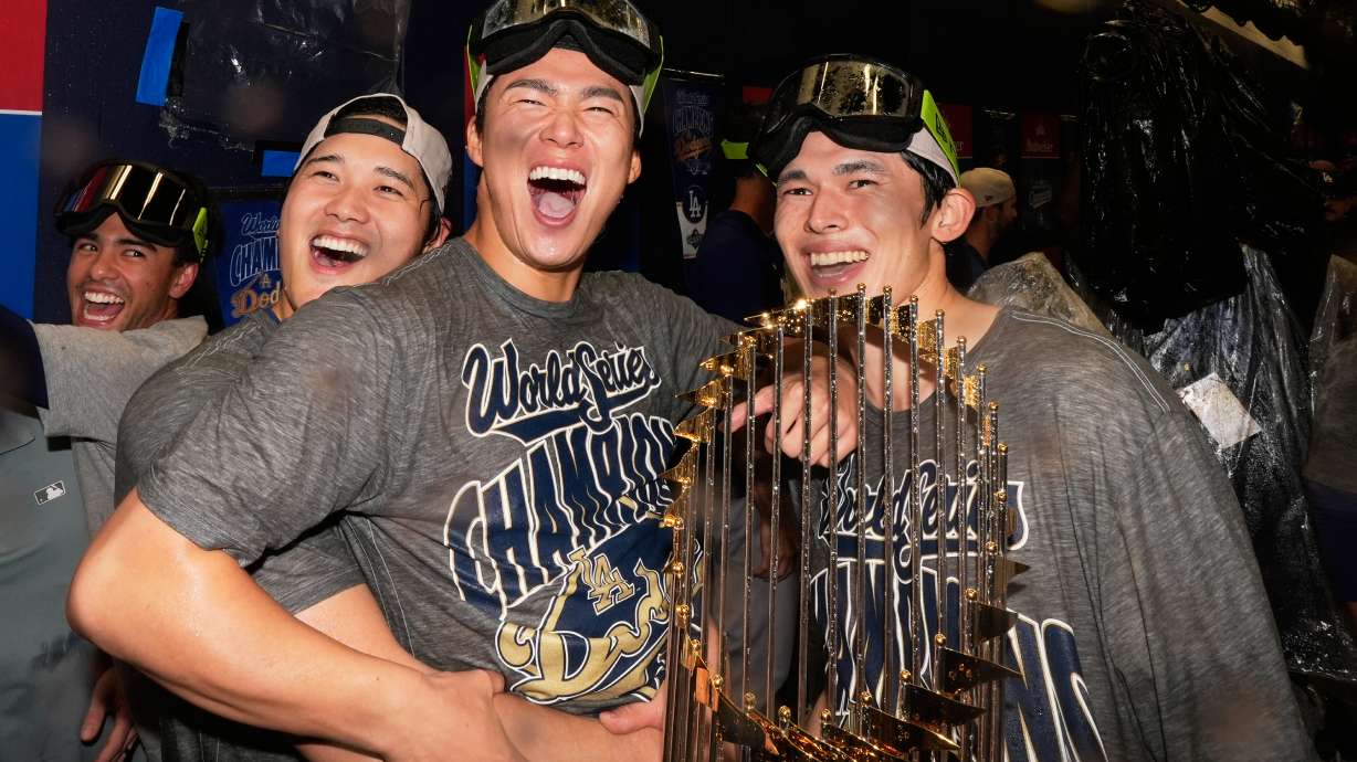 Los Angeles Dodgers pitcher Shohei Ohtani, pitcher Yoshinobu Yamamoto and pitcher Roki Sasaki celebrate after their win against the Toronto Blue Jays in Game 7 of baseball's World Series, Sunday, Nov. 2, 2025, in Toronto.