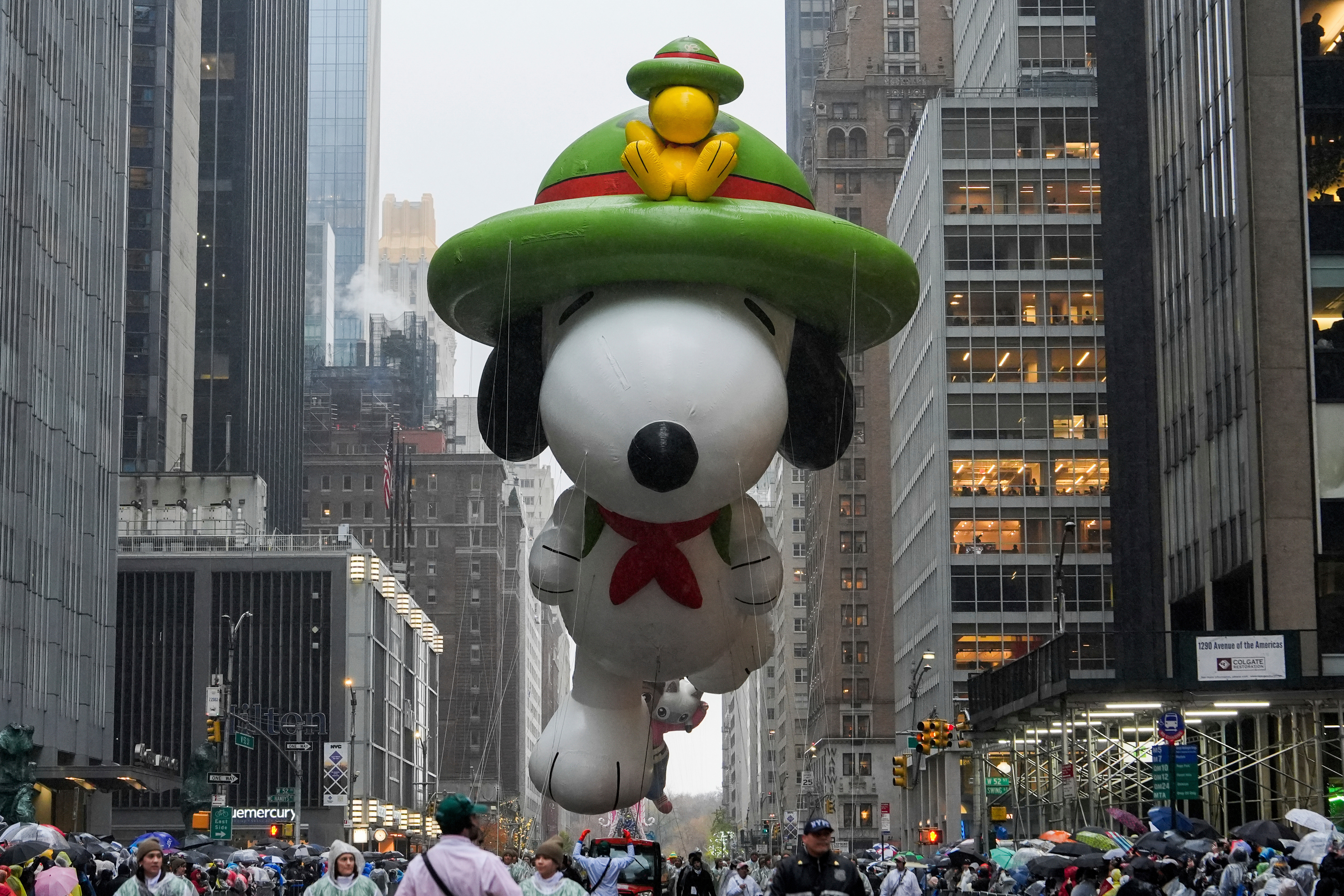 Handlers guide the Snoopy balloon down Sixth Avenue during the Macy's Thanksgiving Day Parade in New York on Nov. 28, 2024.