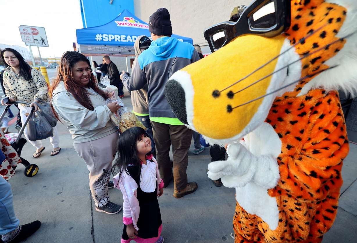 Gloria Ramirez, 4, looks at Chester Cheetah during a grand reopening ceremony outside of Walmart in West Valley City on Friday.