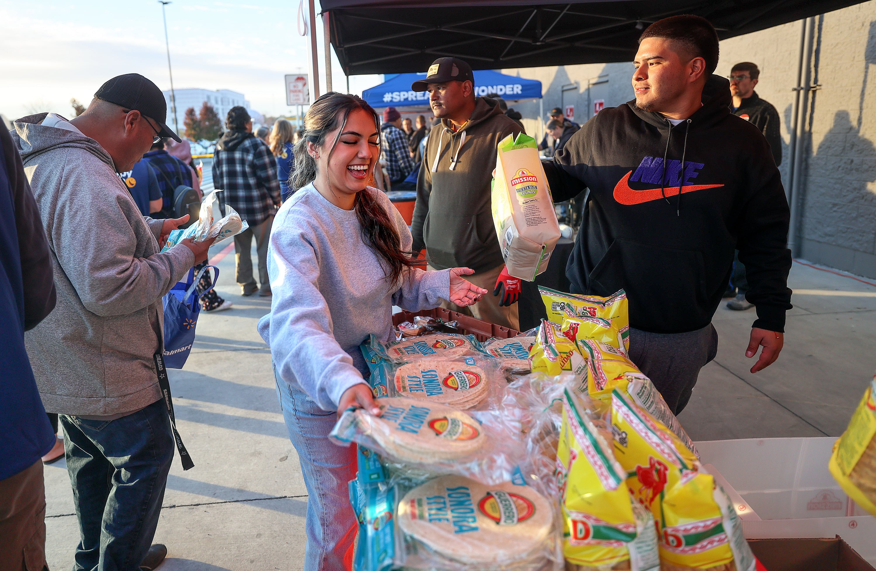 Berenice Pimentel, independent distributor, puts out free tortillas during a grand reopening ceremony outside of Walmart in West Valley City on Friday.