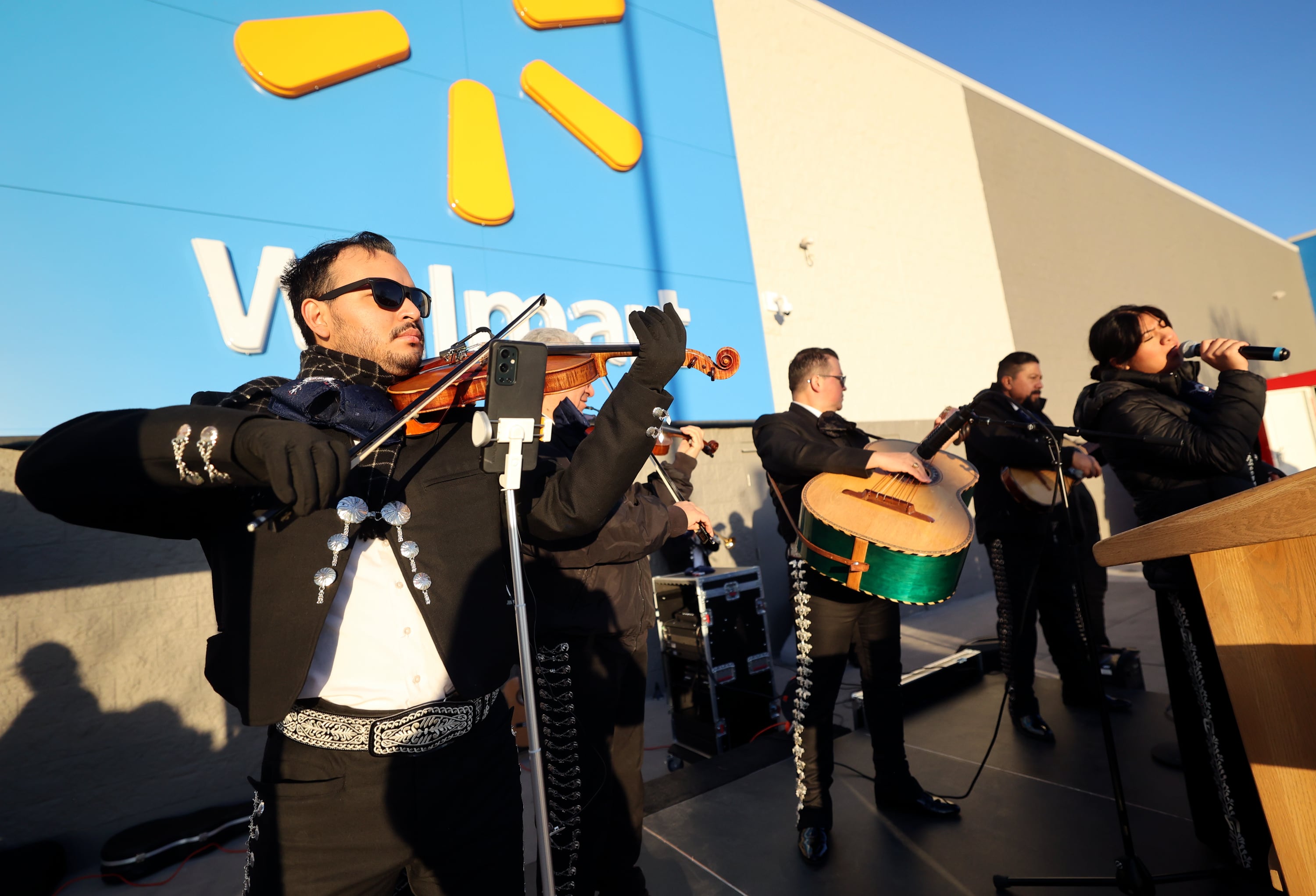 Dennis Rodriguez plays violin with Mariachi America de Utah during a grand reopening ceremony outside of Walmart in West Valley City on Friday.