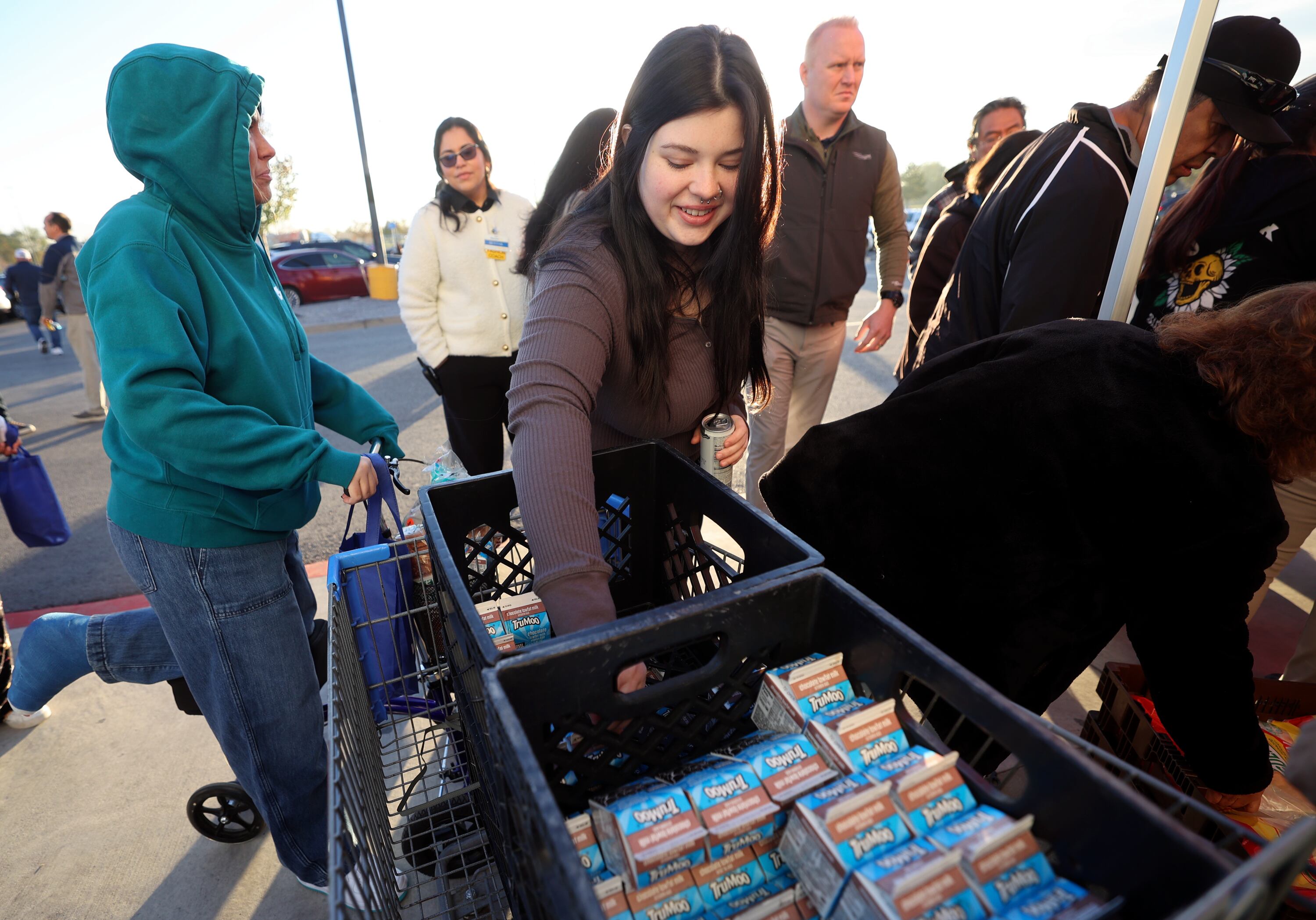 Ashlie King reaches for free milk during a grand reopening ceremony outside of Walmart in West Valley City on Friday.