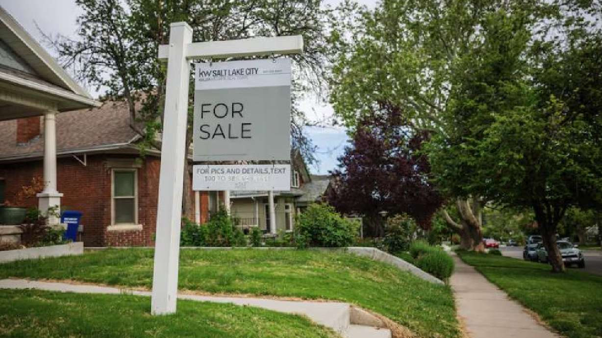 A for-sale sign is posted outside a house in the Avenues neighborhood in Salt Lake City on May 23. A slim majority of Utahns now say they're less likely to make a major purchase this year.
