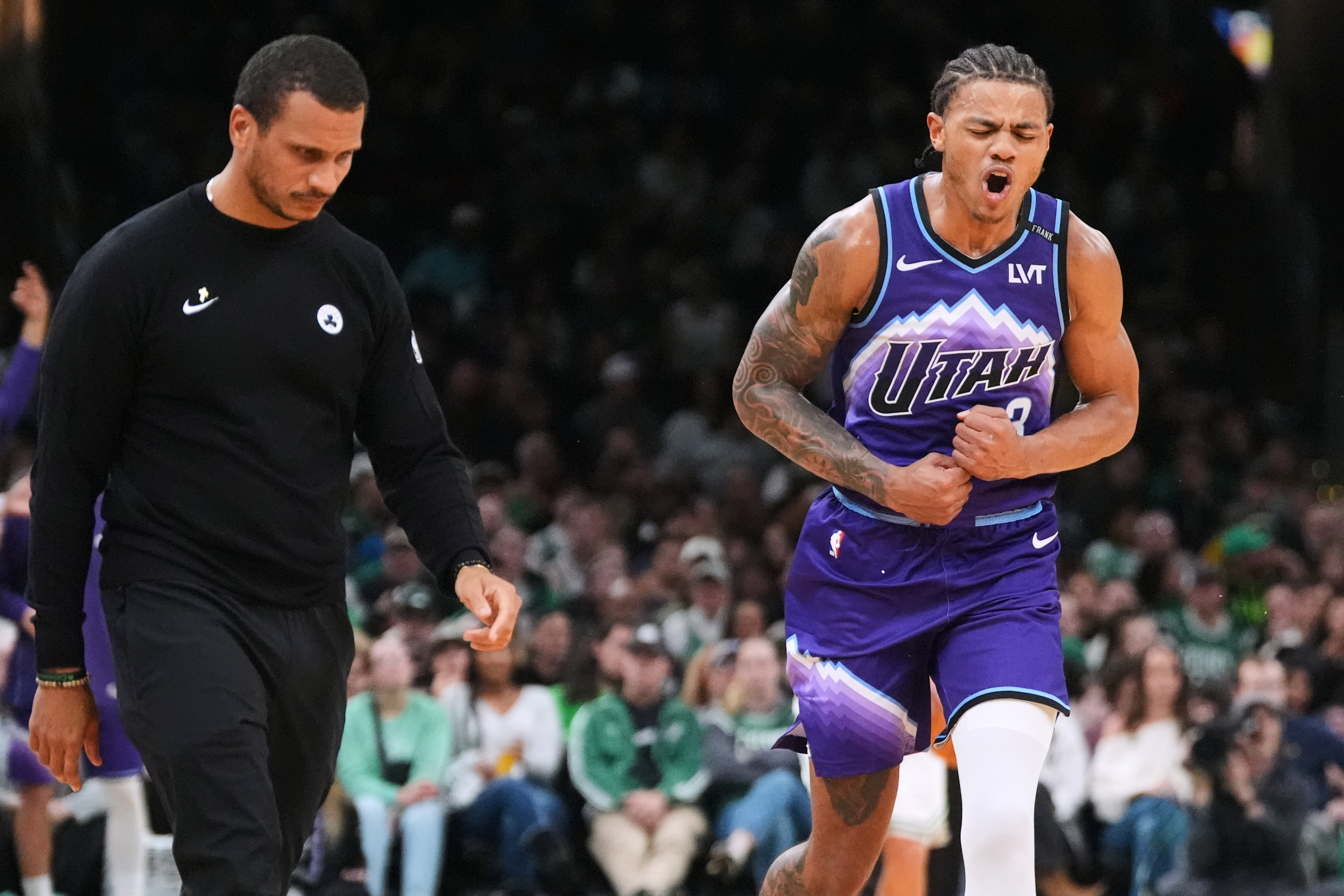 Utah Jazz guard Keyonte George, right, celebrates after hitting a 3-pointer, while passing by Boston Celtics head coach Joe Mazzulla, during second half of an NBA basketball game, Monday, Nov. 3, 2025, in Boston. (AP Photo/Charles Krupa)