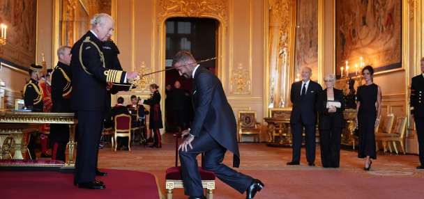 Bend a knee like Beckham: Soccer star is knighted by King Charles III