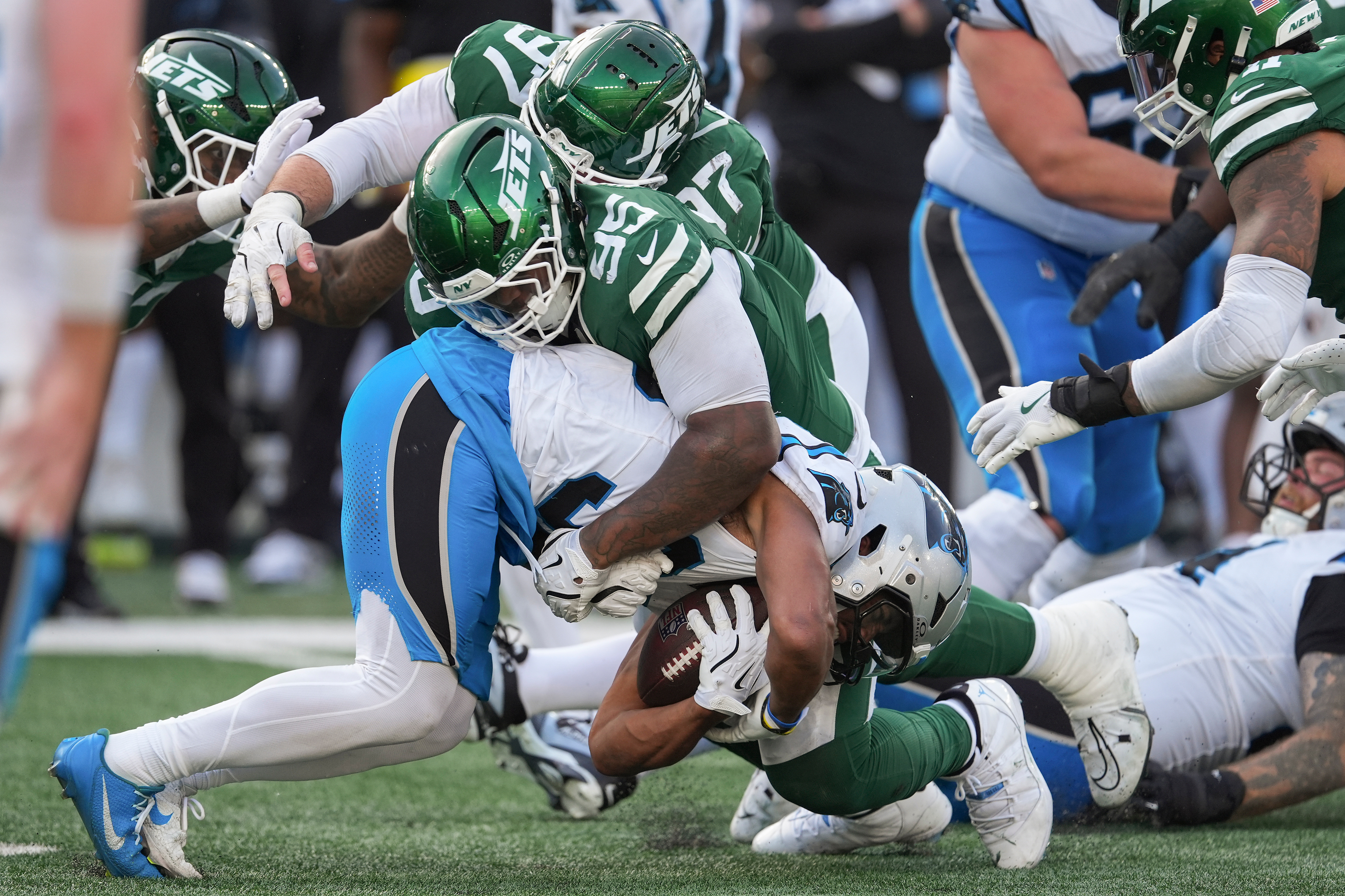 New York Jets defensive tackle Quinnen Williams (95) tackles Carolina Panthers running back Chuba Hubbard (30) during the fourth quarter of an NFL football game, Sunday, Oct. 19, 2025, in East Rutherford, N.J.