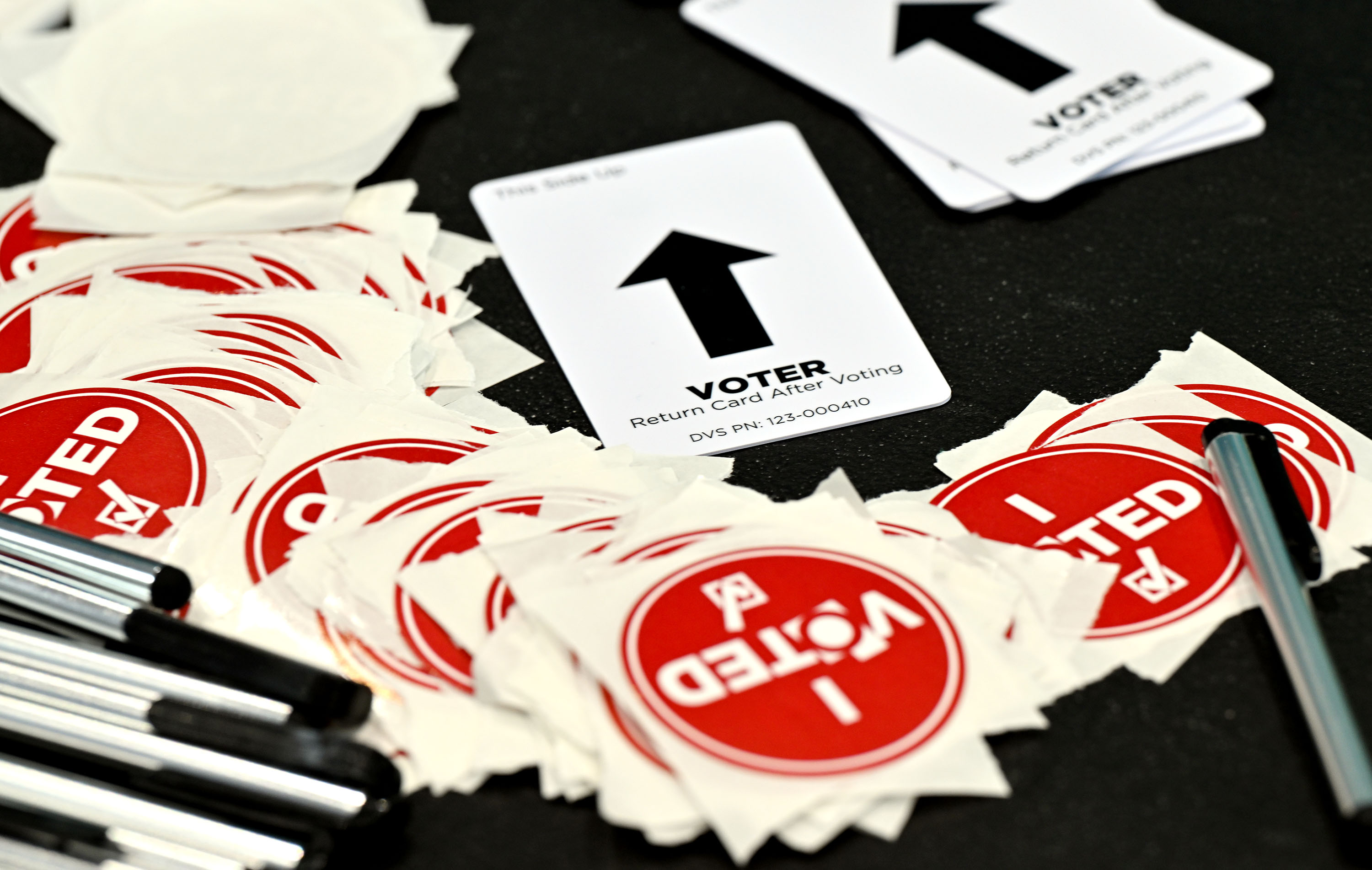 Touch screen stylus, stickers and voting machine cards sit on a table at the Salt Lake County Library in Kearns on Tuesday.