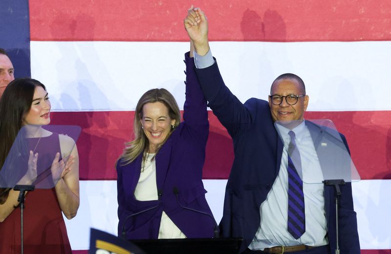 Rep. Mikie Sherrill, Democratic gubernatorial candidate for New Jersey and Lt. Gov.-elect Dale Caldwell react on stage at her election night rally after media projected that she won, in East Brunswick, N.J., Tuesday. Sherrill will succeed Gov. Phil Murphy.