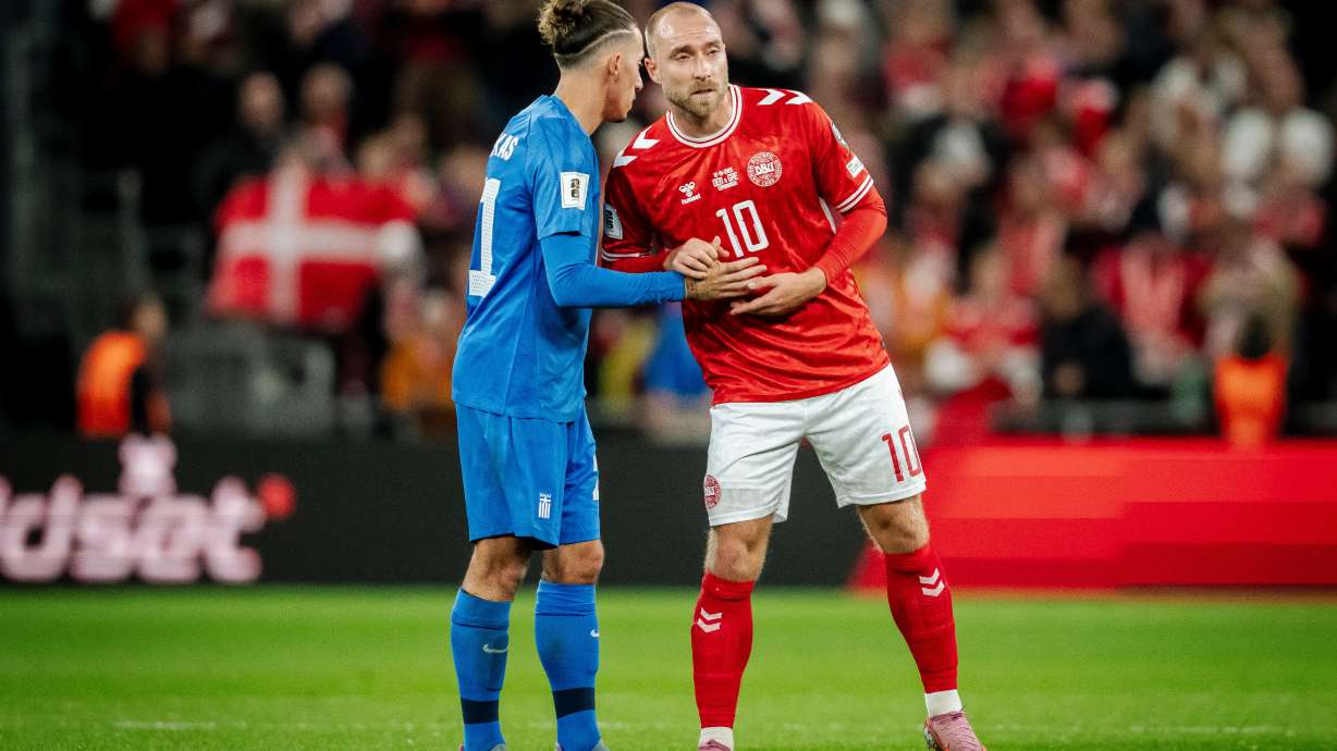 Greece's Kostas Tsimikas, left, and Denmark's Christian Eriksen, right, meet after the World Cup Group C qualification match between Denmark and Greece at Parken stadium in Copenhagen, Sunday, Oct. 12, 2025.