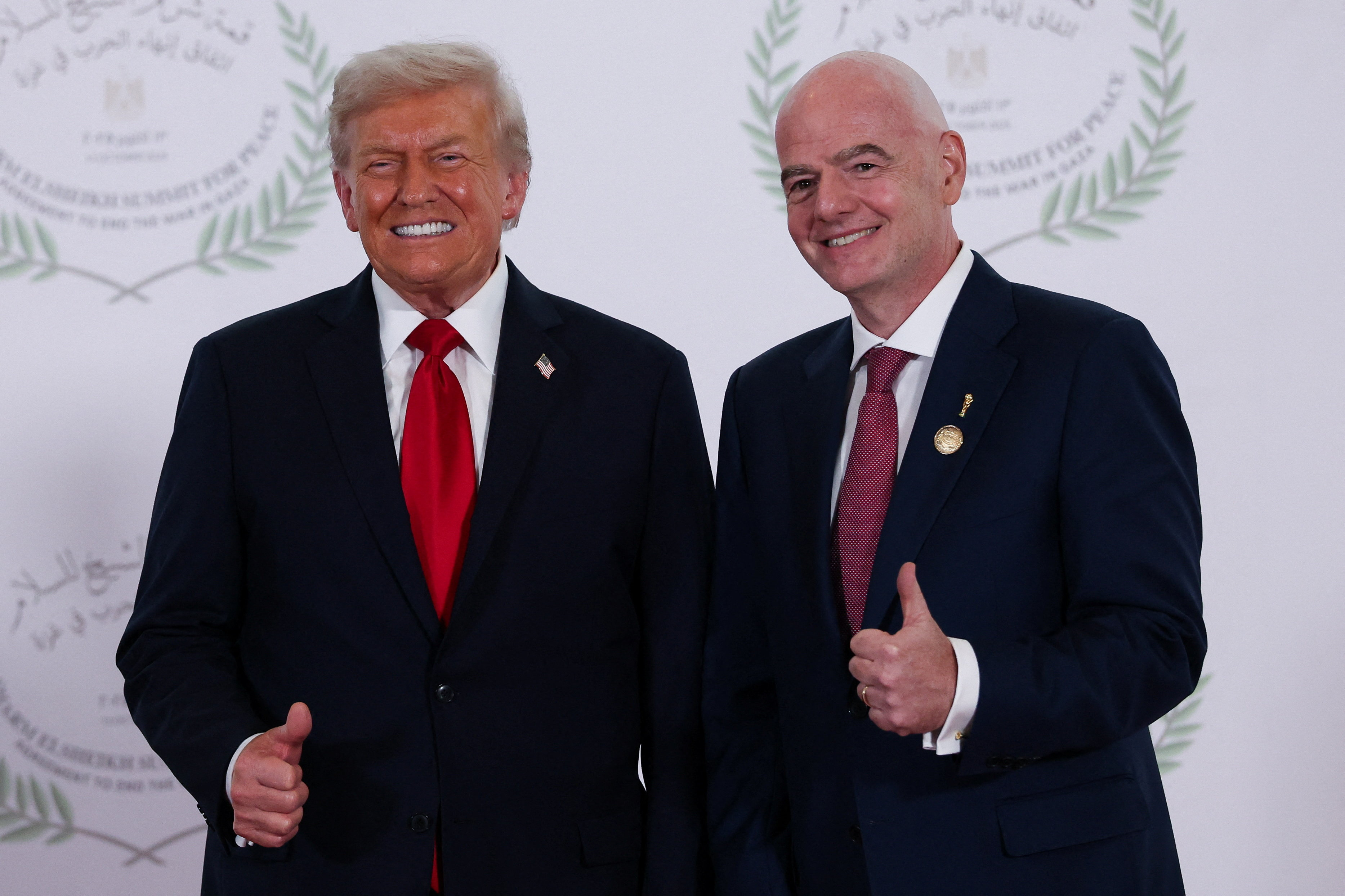 President Donald Trump and FIFA president Gianni Infantino pose for a photo in Sharm el-Sheikh, Egypt, Monday, Oct. 13, 2025.