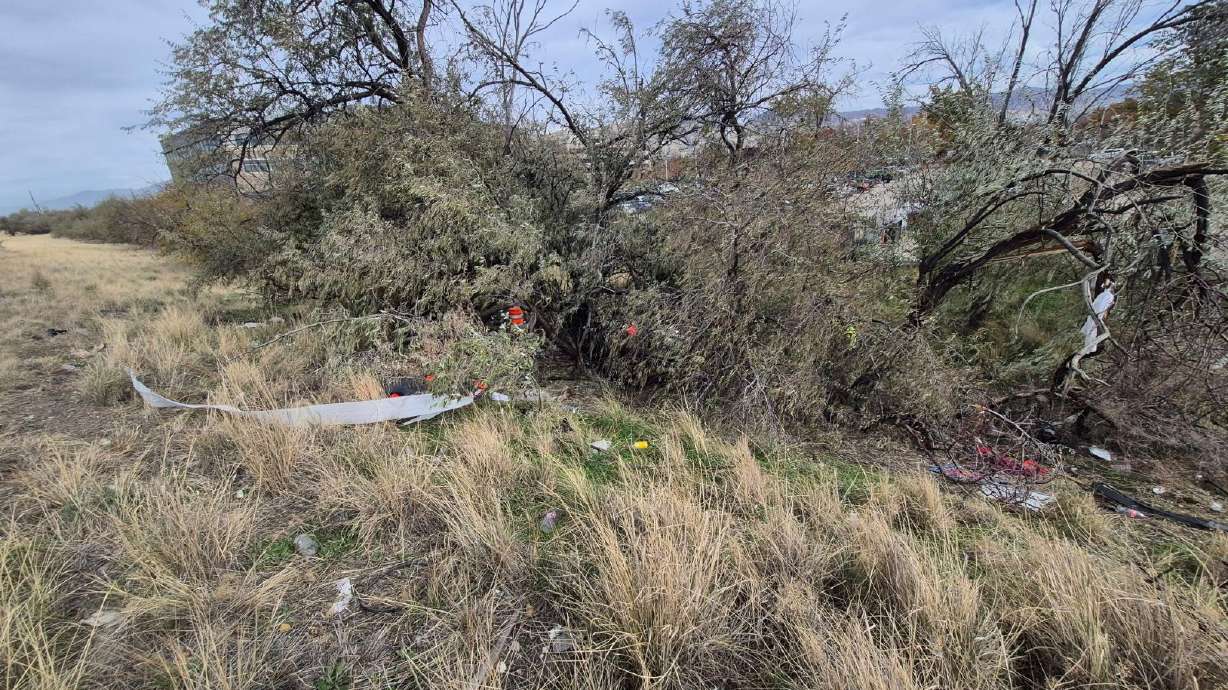 Utah Highway Patrol troopers investigate the scene of a fatal car crash near the I-215 and I-80 interchange, by the Salt Lake City International Airport, on Wednesday.