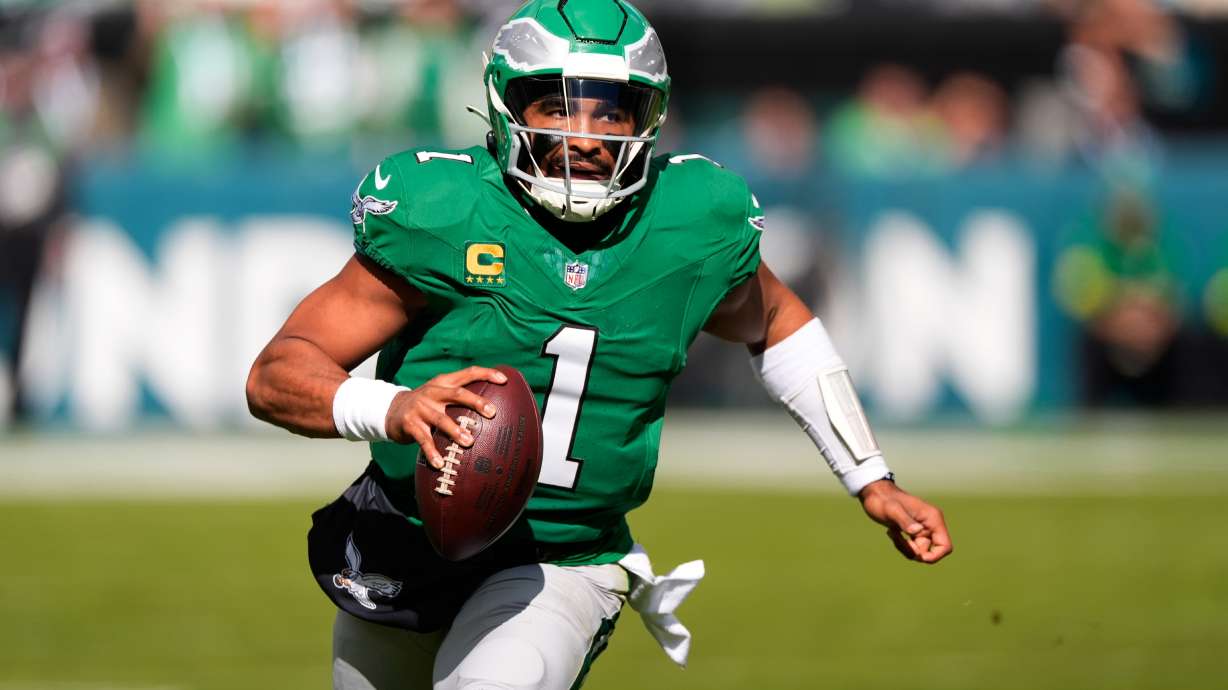 Philadelphia Eagles quarterback Jalen Hurts (1) runs with the ball during the first half of an NFL football game against the New York Giants on Sunday, Oct. 26, 2025, in Philadelphia.