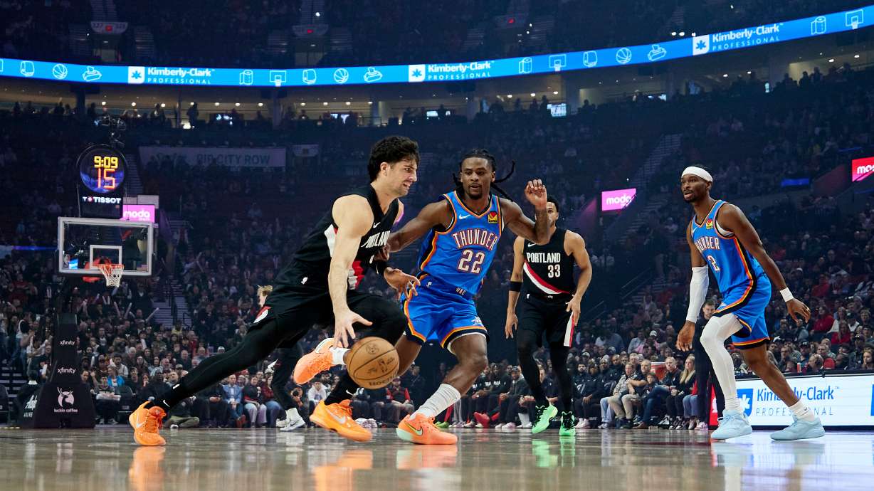Portland Trail Blazers forward Deni Avdija, left, dribbles past Oklahoma City Thunder guard Cason Wallace during the first half of an NBA basketball game in Portland, Ore., Wednesday, Nov. 5, 2025.