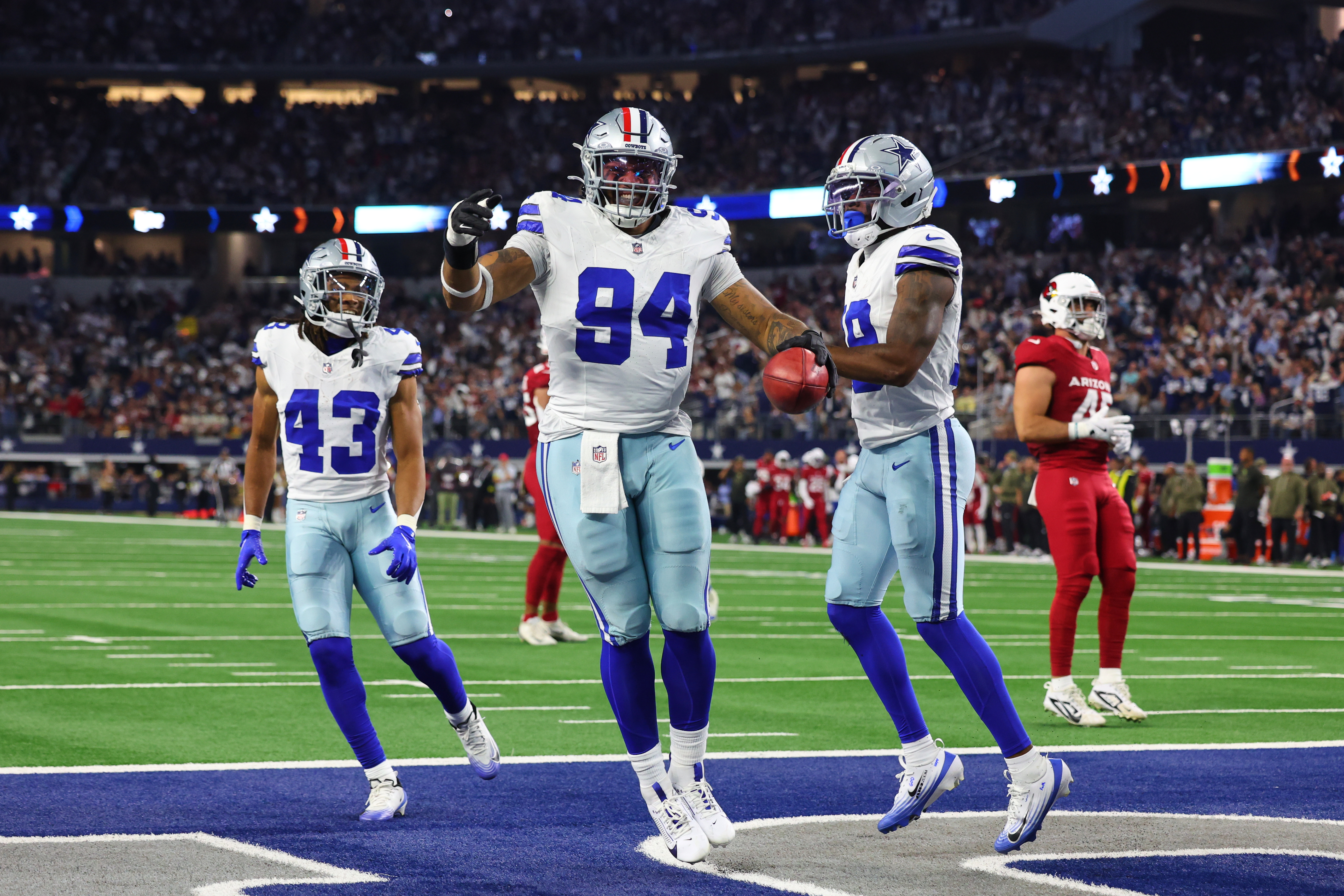 Dallas Cowboys defensive end Marshawn Kneeland (94), Malik Davis (43) and Damone Clark, right, celebrate after Kneeland recovered a blocked punt for a touchdown in the first half of an NFL football game against the Arizona Cardinals Monday, Nov. 3, 2025, in Arlington, Texas. Marshawn was found dead Thursday. He was 24.