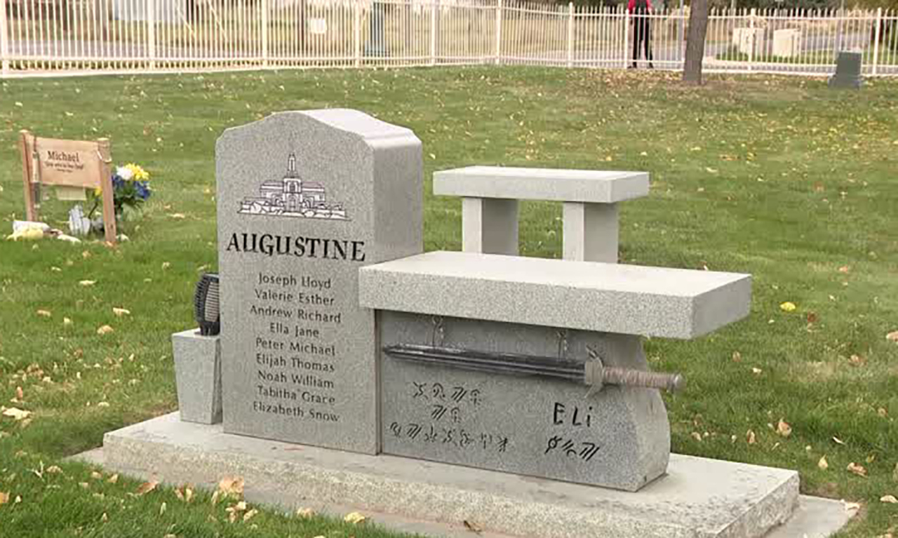 The grave of Eli Augustine is shown in Lehi on Wednesday. His mother says someone apparently stole Halloween decorations from the site.
