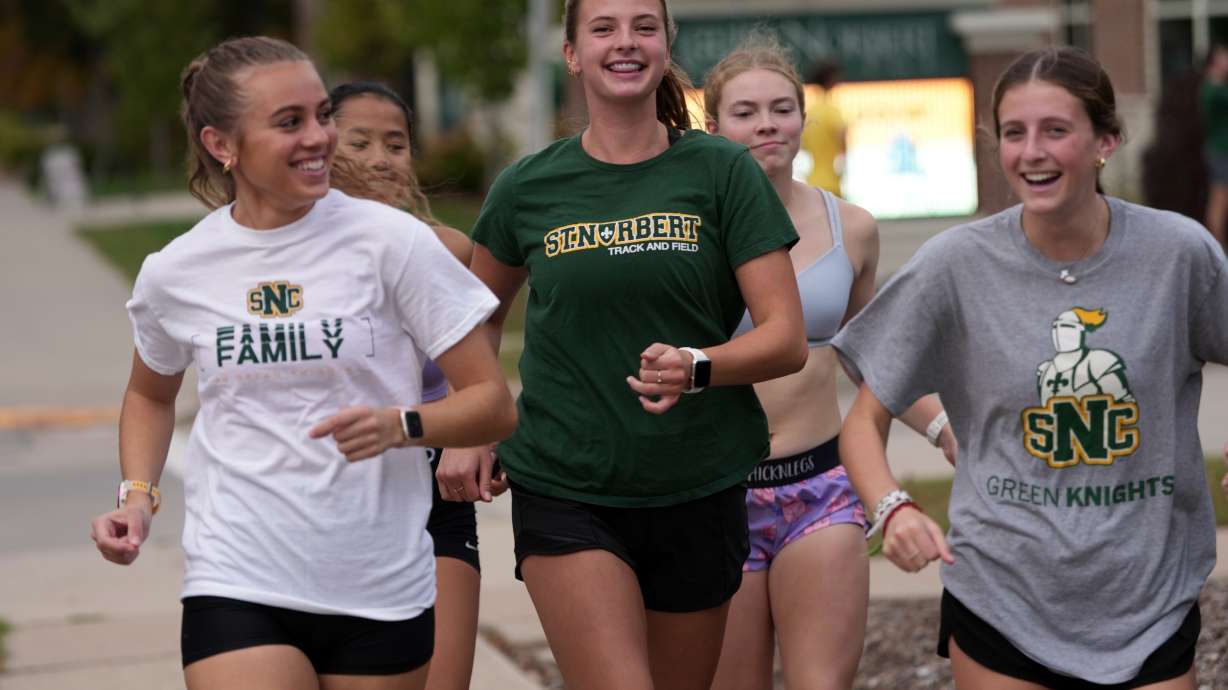 Cross country runner Madison DeCleene, center, runs with her St. Norbert College teammates, Friday, Oct. 17, 2025, in De Pere, Wis.