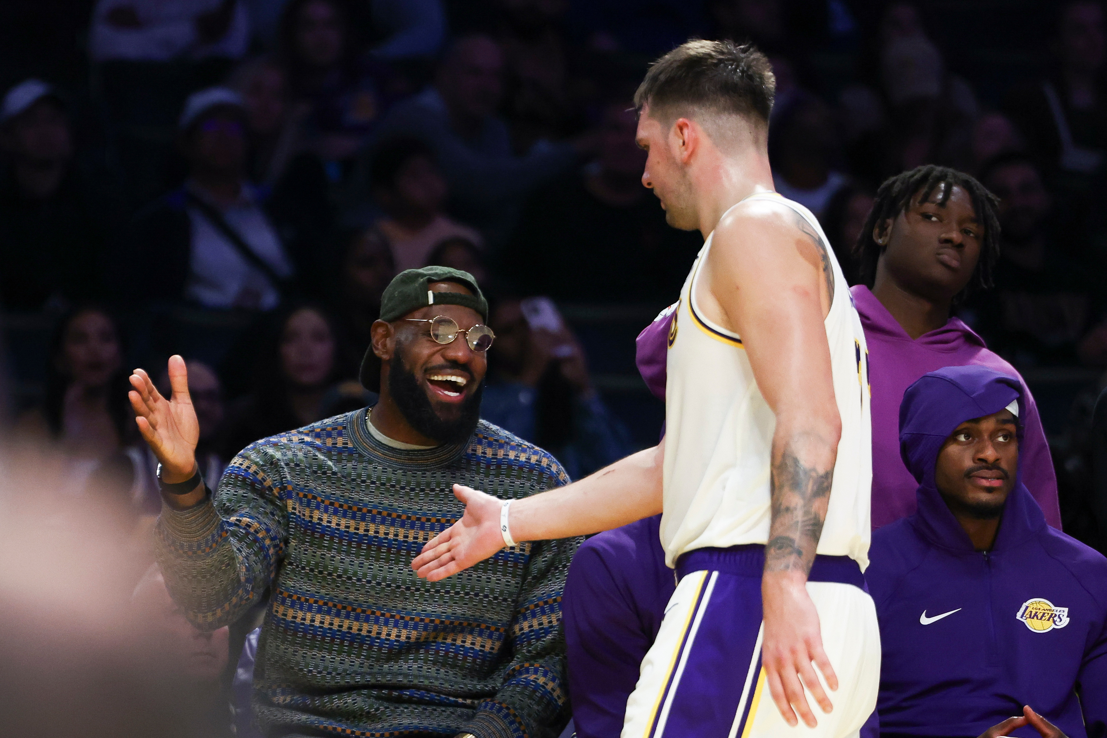 Los Angeles Lakers forward LeBron James, left, and guard Luka Doncic, center, celebrate as forward Jarred Vanderbilt, right, looks on during the second half of an NBA basketball game against the Miami Heat, Sunday, Nov. 2, 2025, in Los Angeles.