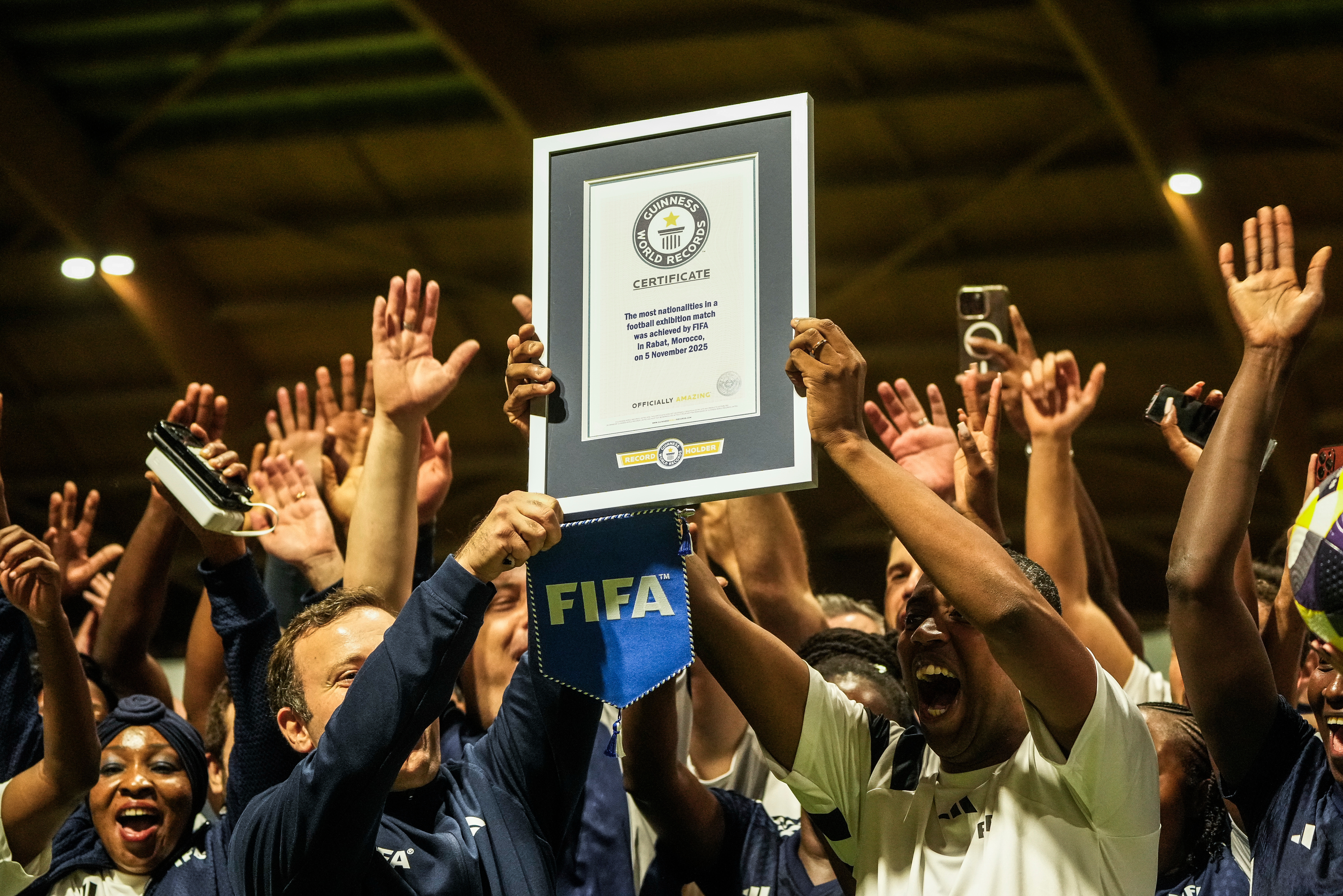 People celebrate after breaking the Guinness World Record for most nationalities in an exhibition soccer match organized by FIFA, in Rabat, Morocco, Wednesday, Nov. 5, 2025.
