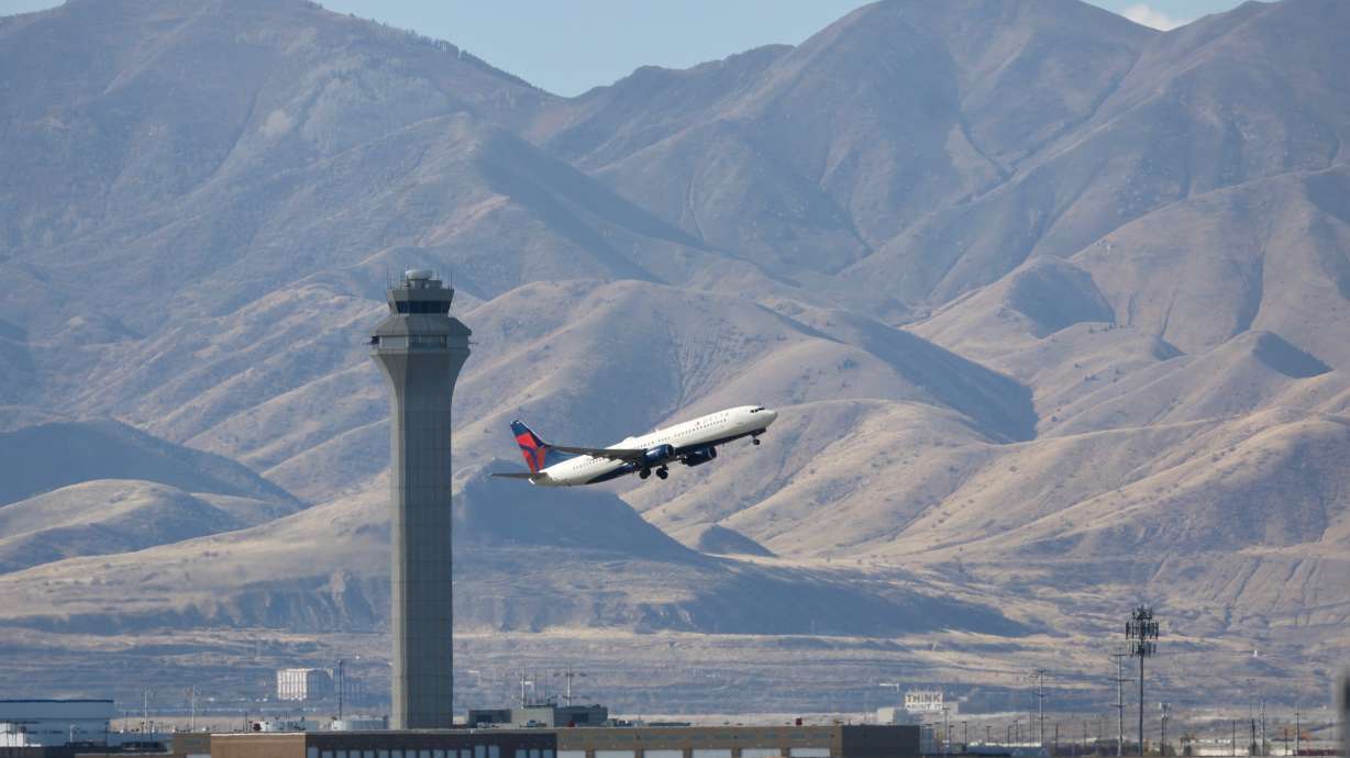 A plane takes off from Salt Lake City International Airport in Salt Lake City on Thursday. The airport is one of 40 that will see service reductions starting on Friday due to the government shutdown.