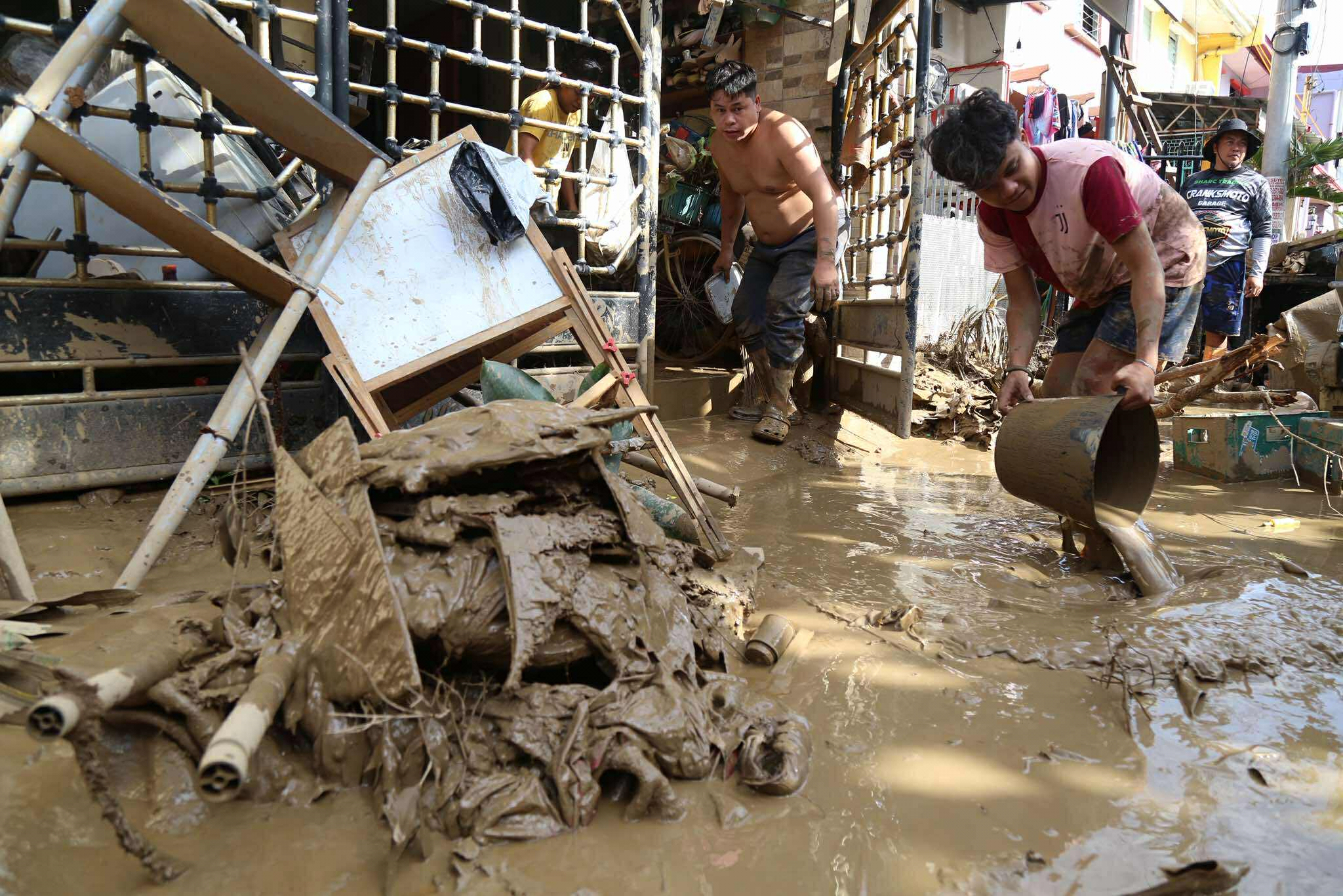Residents clean up after Typhoon Kalmaegi caused devastation in communities at Talisay City, Cebu province, central Philippines, Wednesday. Tropical cyclones like Kalmaegi are the same but different in different parts of the world.