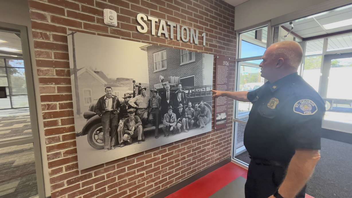 St. George Fire Chief Robert Stoker points at a historic photo of early fire department members, as he shows the new Station 1 on Oct. 29. The station celebrates the city's history in many of its features.