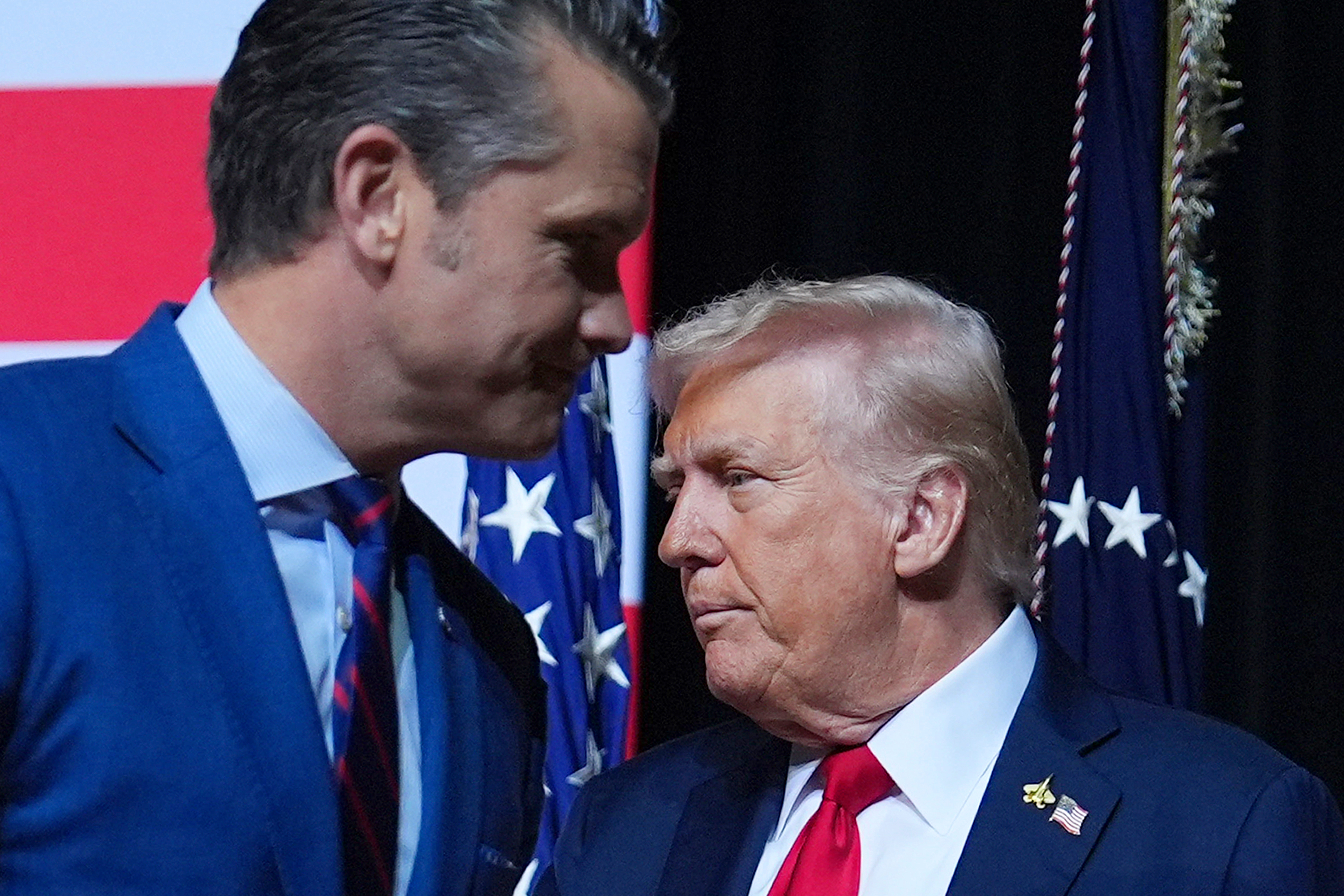 President Donald Trump is greeted by Secretary of Defense Pete Hegseth before speaking to a gathering of top U.S. military commanders at Marine Corps Base Quantico, Sept. 30, in Quantico, Va. Hegseth said Monday that the U.S. struck two more alleged drug-carrying vessels in the eastern Pacific Ocean over the weekend, killing six people on board.