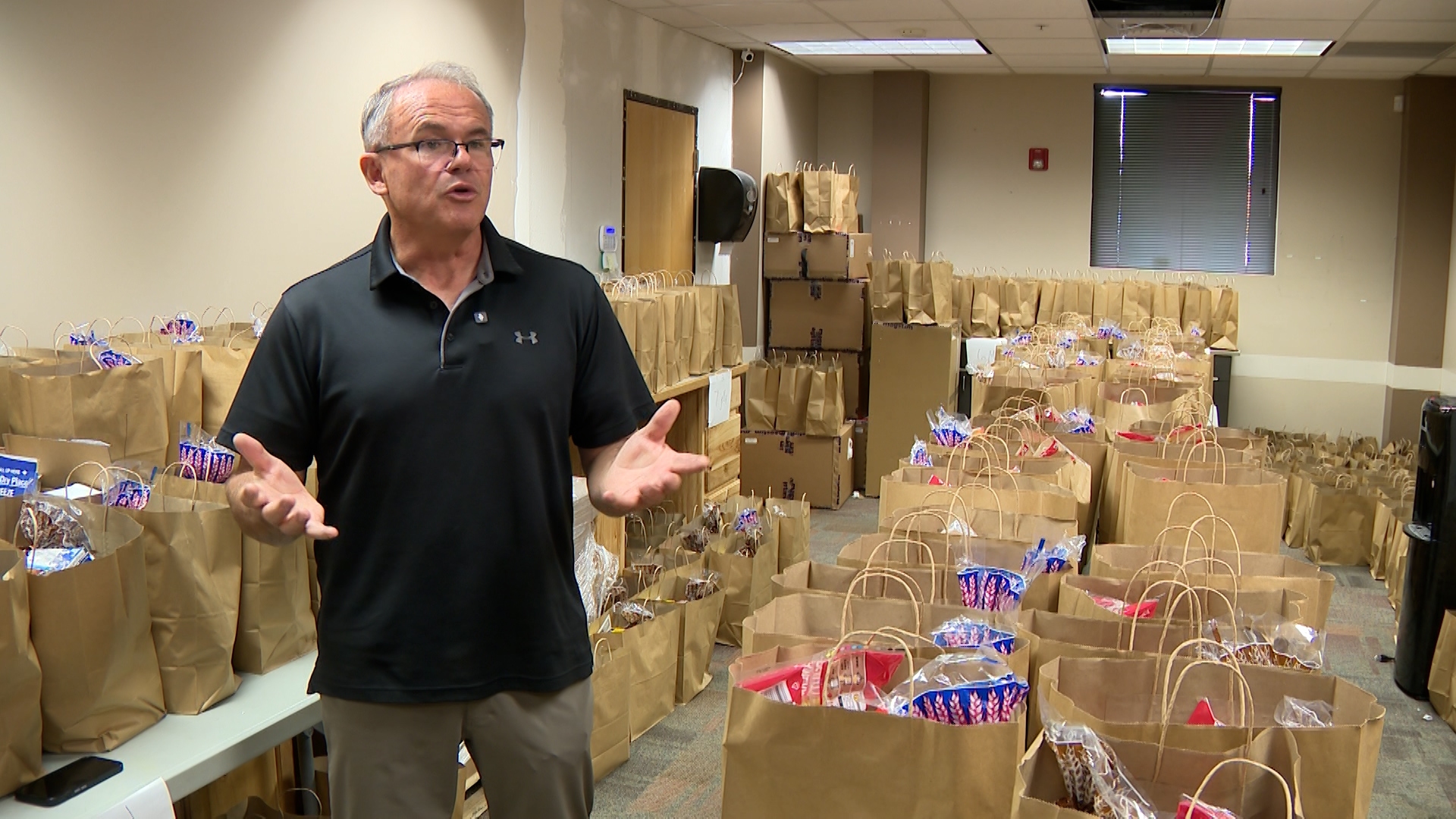 Kevin Eastman, executive director at Weber Human Services, shows food bags that are being compiled for about 300 families, Thursday. Eastman said the support they've been receiving is "overwhelming."