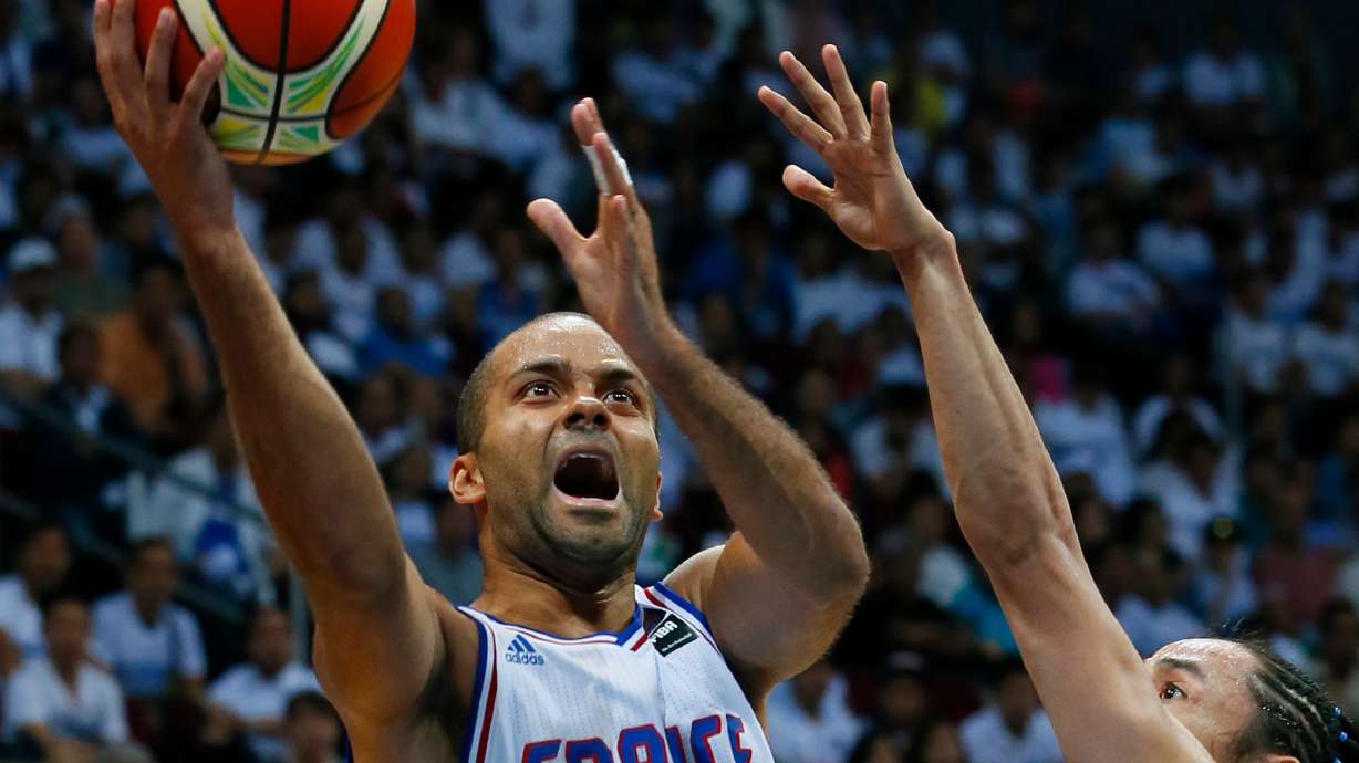 FILE - Tony Parker of France shoots the ball over the Philippines' Jeff Chan during the Group B FIBA Olympics Qualifying basketball match Tuesday, July 5, 2016 in suburban Pasay city south of Manila, Philippines. France won 93-84.