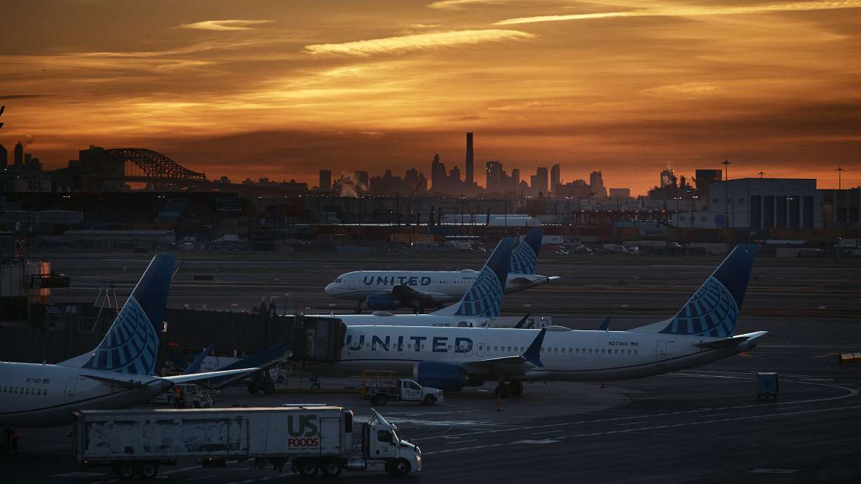 Planes are seen at Newark Liberty International Airport on Friday, in Newark, N.J. Anxious travelers felt a bit of relief as airlines mostly stayed on schedule while gradually cutting flights because of the government shutdown.