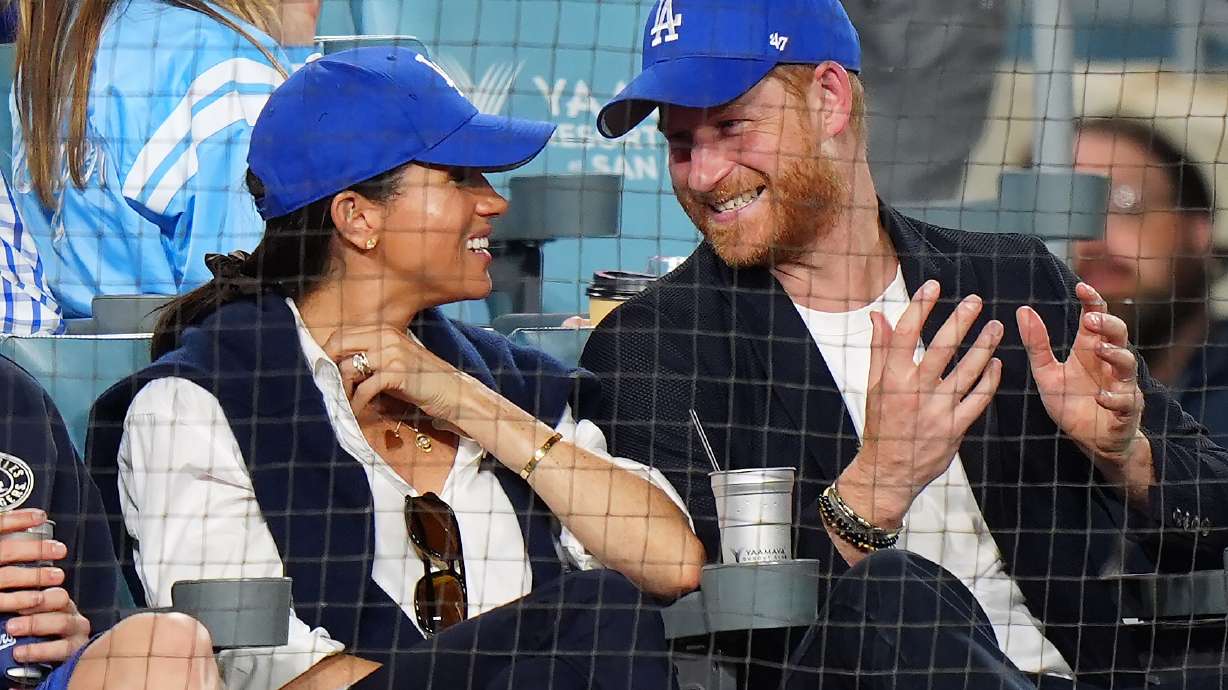 Prince Harry, right, and Meghan Markle, Duke and Duchess of Sussex, sit during the eighth inning in Game 4 of baseball's World Series between the Los Angeles Dodgers and the Toronto Blue Jays in Los Angeles, Tuesday, Oct. 28, 2025.
