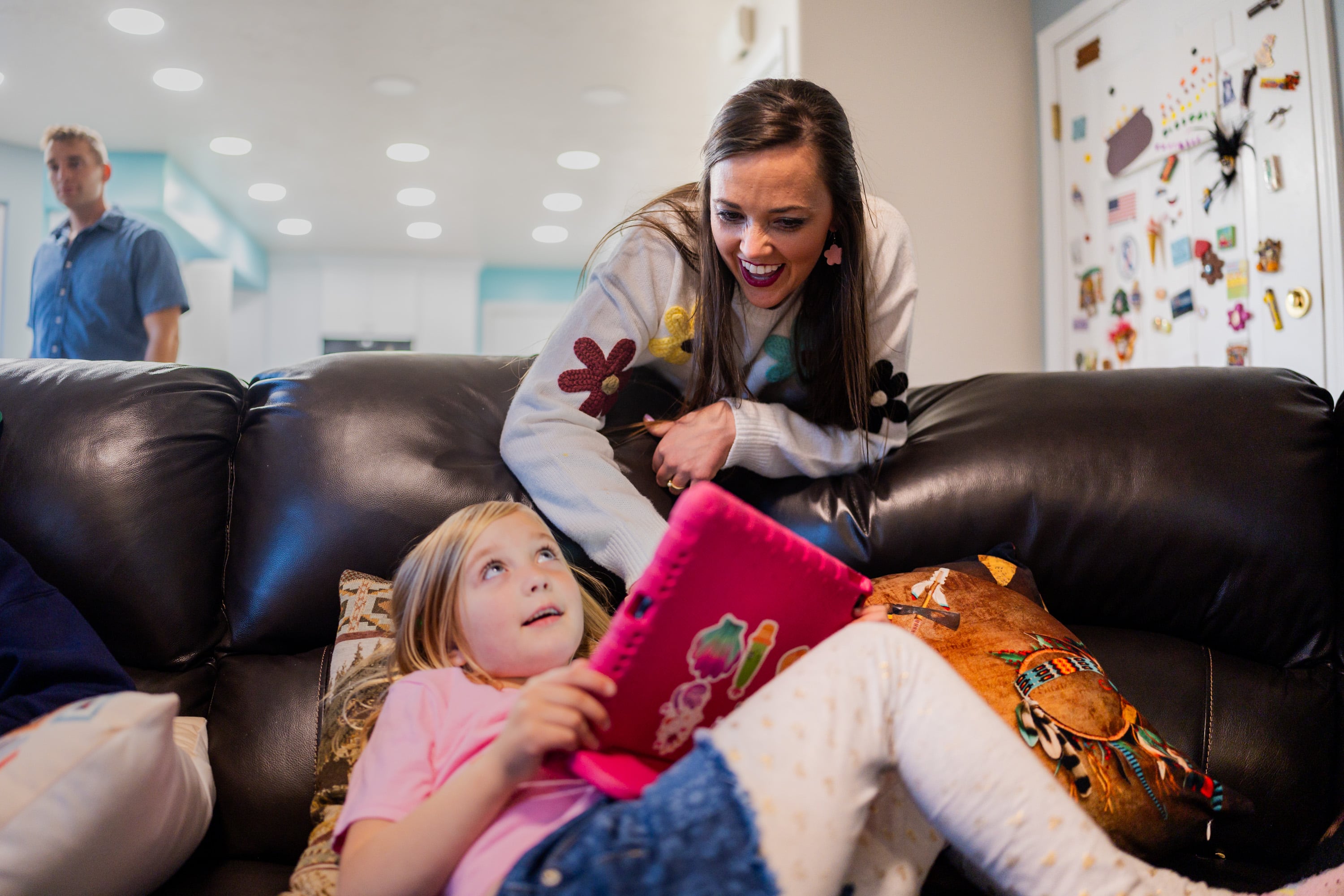 Philly Clancy, 5, listens to signed stories, where an interpreter signs along to the words, while her mother Stephanie Clancy, a movement teacher at Majestic Elementary Arts Academy, leans in to ask comprehension questions at their home in South Jordan on Thursday.