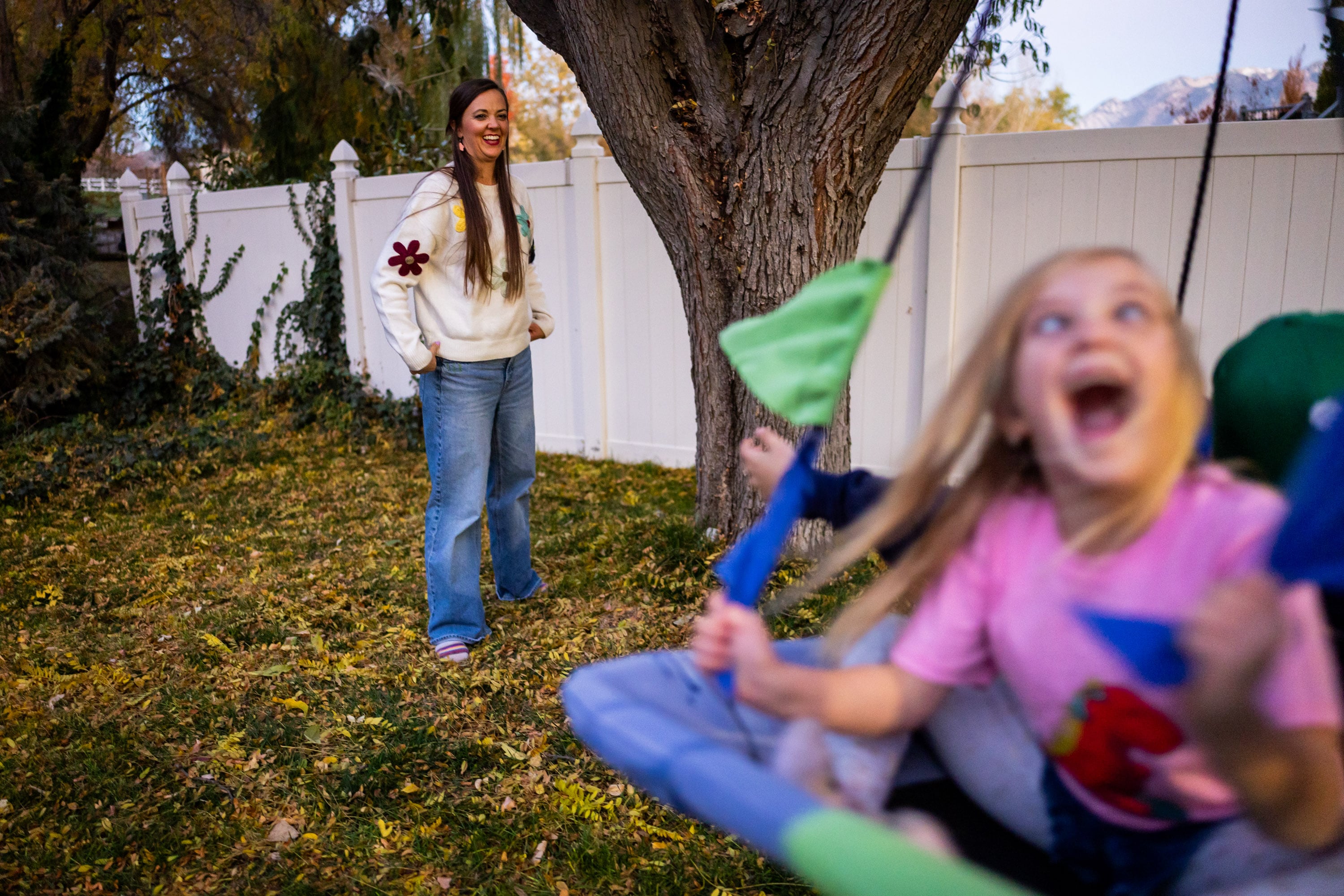 Philly Clancy, 5, a student at the Jean Massieu School of the Deaf, right, plays on a swing after she finished her after-school reading time while her mother Stephanie Clancy, movement teacher at Majestic Elementary Arts Academy, watches at their home in South Jordan on Thursday. Being engaged in your child's education can have farther-reaching effects than parents think.