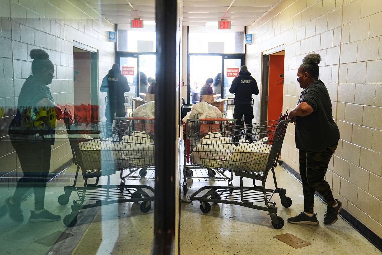 Volunteer Karen Robinson moves groceries during an emergency food distribution at The Jewish Federation of Greater Philadelphia's Mitzvah Food Program in Philadelphia, Friday. Pennsylvania was one of several states that released SNAP benefits.