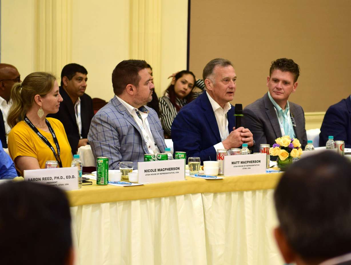 World Trade Center Utah COO David Carlebach speaking at the IMC Chamber of Commerce, Churchgate, Mumbai, India. Utah state Rep. Matt MacPherson (left), his wife, Nicole, and Utah state Rep. Jason Thompson (right) were also in attendance. The delegation was part of a trade mission organized by the state.