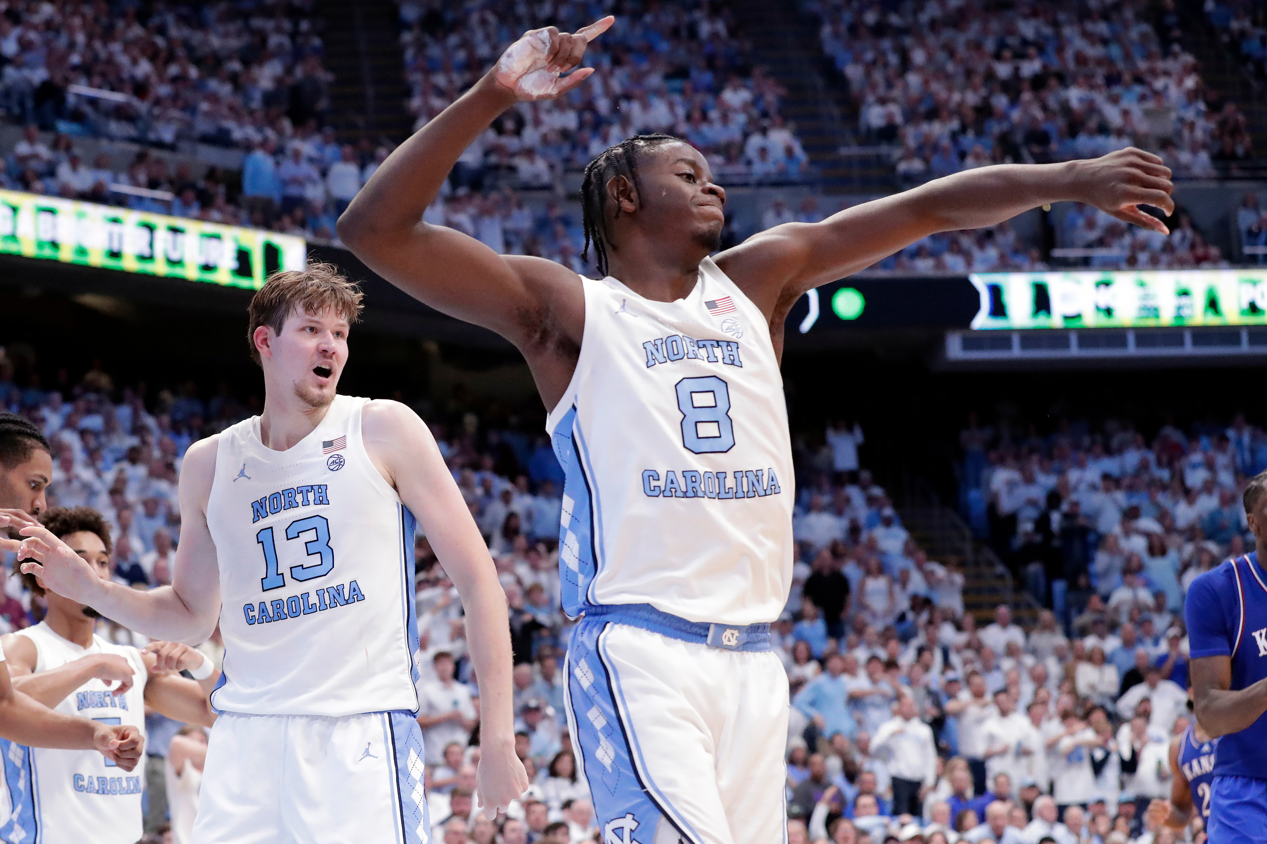 North Carolina center Henri Veesaar (13) and forward Caleb Wilson (8) celebrate a turnover by Kansas during the second half of an NCAA college basketball game Friday, Nov. 7, 2025, in Chapel Hill, N.C.