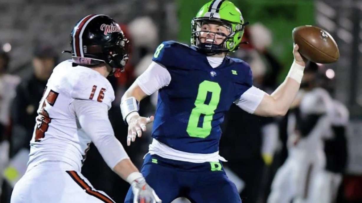Ridgeline quarterback Nate Dahle (8) throws the ball as Park City’s Wyatt Knapp defends Friday night in Millville.