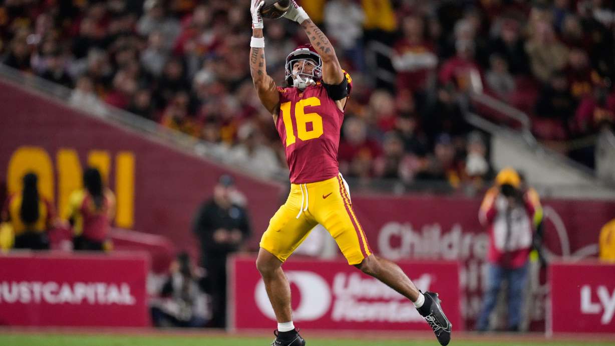 Southern California wide receiver Tanook Hines catches a pass thrown by punter Sam Johnson during the first half of an NCAA college football game against Northwestern, Friday, Nov. 7, 2025, in Los Angeles.