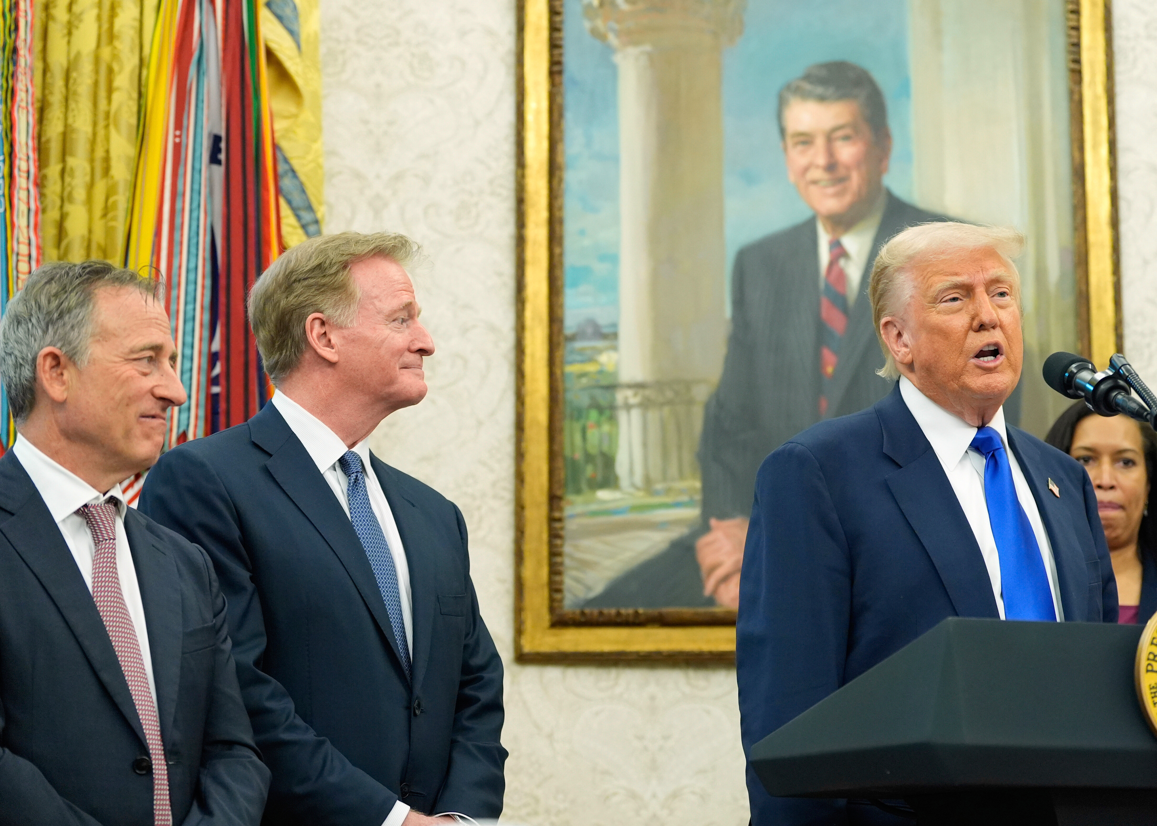 FILE - President Donald Trump speaks as Washington Commanders owner Josh Harris, from left, NFL Commissioner Roger Goodell and District of Columbia Mayor Muriel Bowser listen during an event in the Oval Office of the White House, May 5, 2025, in Washington.