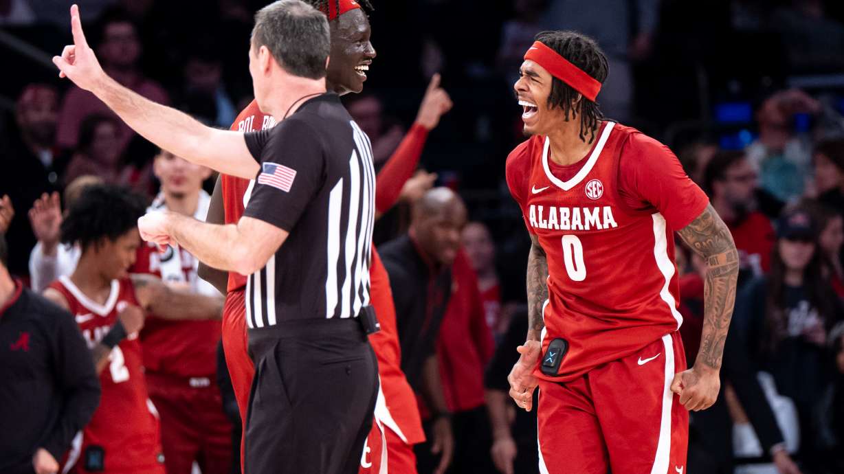 Alabama forward Taylor Bol Bowen (7) and guard Labaron Philon (0) celebrate a basket near the end of an NCAA college basketball game against St. John's, Saturday, Nov. 8, 2025, in New York.
