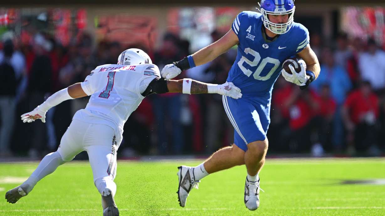 BYU Cougars tight end Carsen Ryan (20) sheds Texas Tech Red Raiders defensive back AJ McCarty (1) off as BYU and Texas Tech play at Jones AT&T Stadium in Lubbock Texas on Saturday, Nov. 8, 2025.