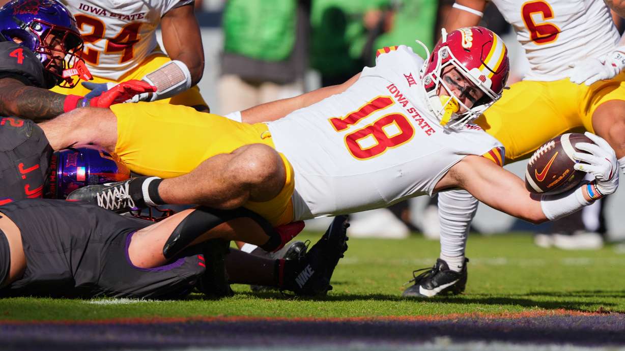 Iowa State tight end Benjamin Brahmer (18) scores a touchdown against TCU defenders Vernon Glover (26), Jamel Johnson (2) and Devean Deal (11) during the first half of an NCAA college football game Saturday, Nov. 8, 2025, in Fort Worth, Texas.