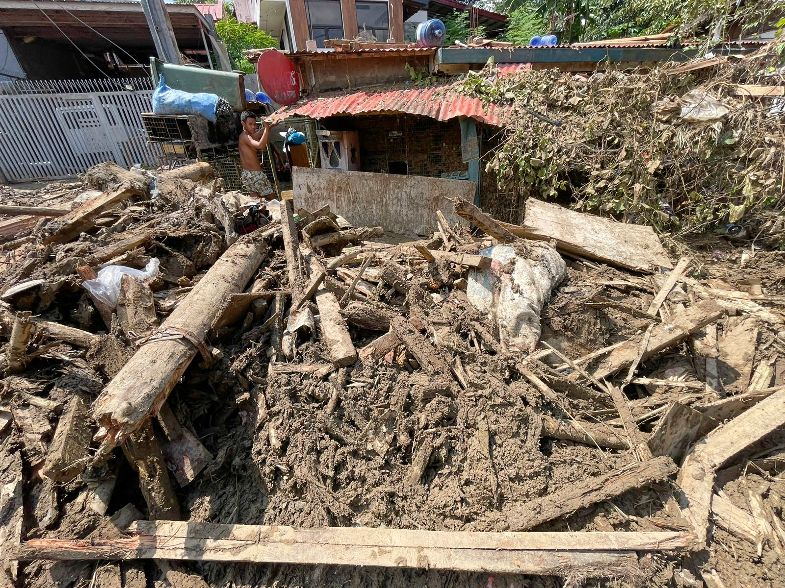 Debris lays outside a house as residents return to their flood damaged homes in Bacayan, Cebu province, central Philippines on Friday after Typhoon Kalmaegi devastated the province and claimed lives.