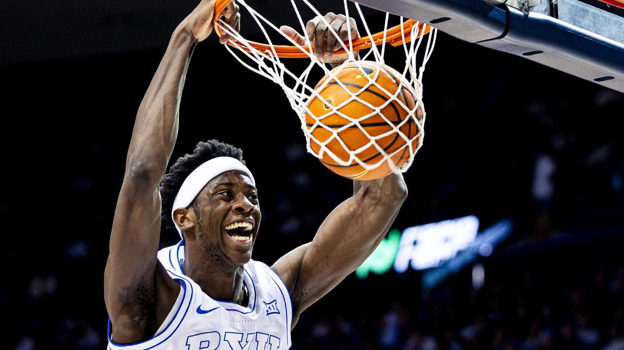 BYU forward AJ Dybantsa (3) dunks the ball during an NCAA men’s basketball game against Holy Cross held at the Marriott Center in Provo on Saturday, Nov. 8, 2025.