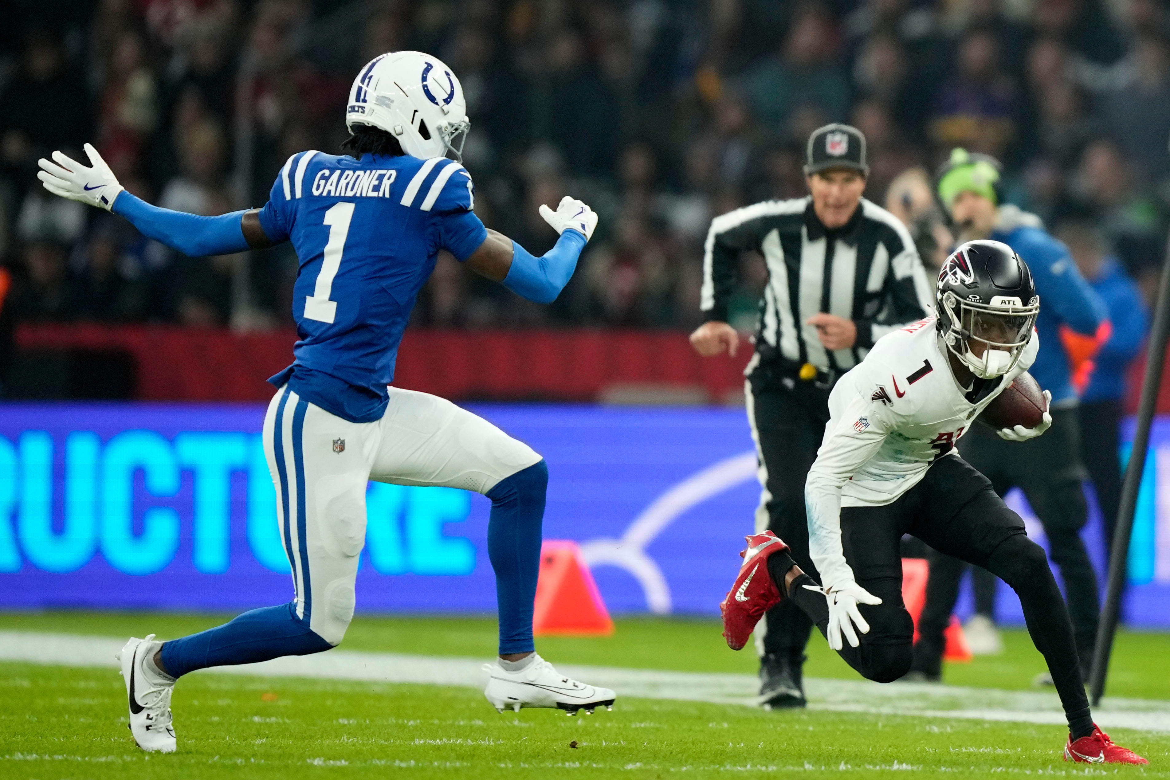 Atlanta Falcons wide receiver Darnell Mooney, right, runs from Indianapolis Colts cornerback Sauce Gardner during the first half of an NFL football game, Sunday, Nov. 9, 2025, in Berlin, Germany.