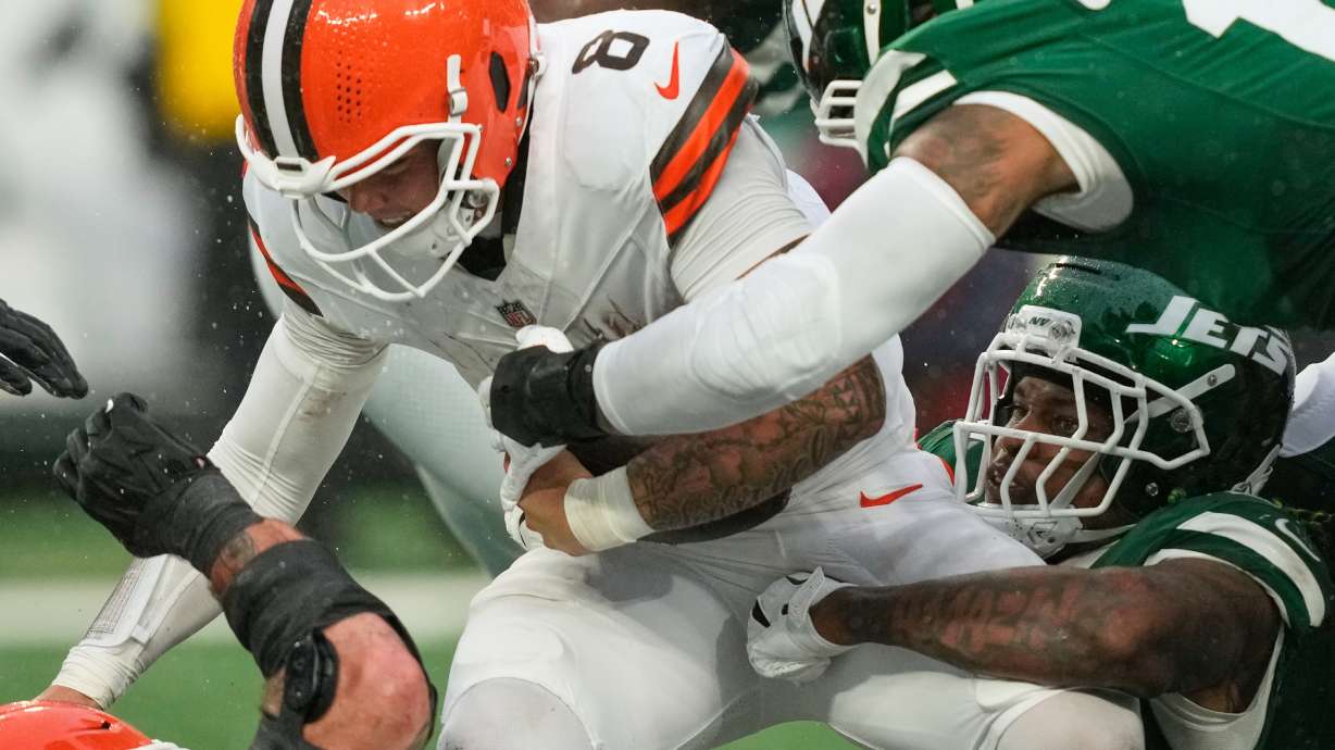Cleveland Browns quarterback Dillon Gabriel (8) is sacked by New York Jets linebacker Quincy Williams, bottom right, in the second half of an NFL football game Sunday, Nov. 9, 2025, in East Rutherford, N.J.