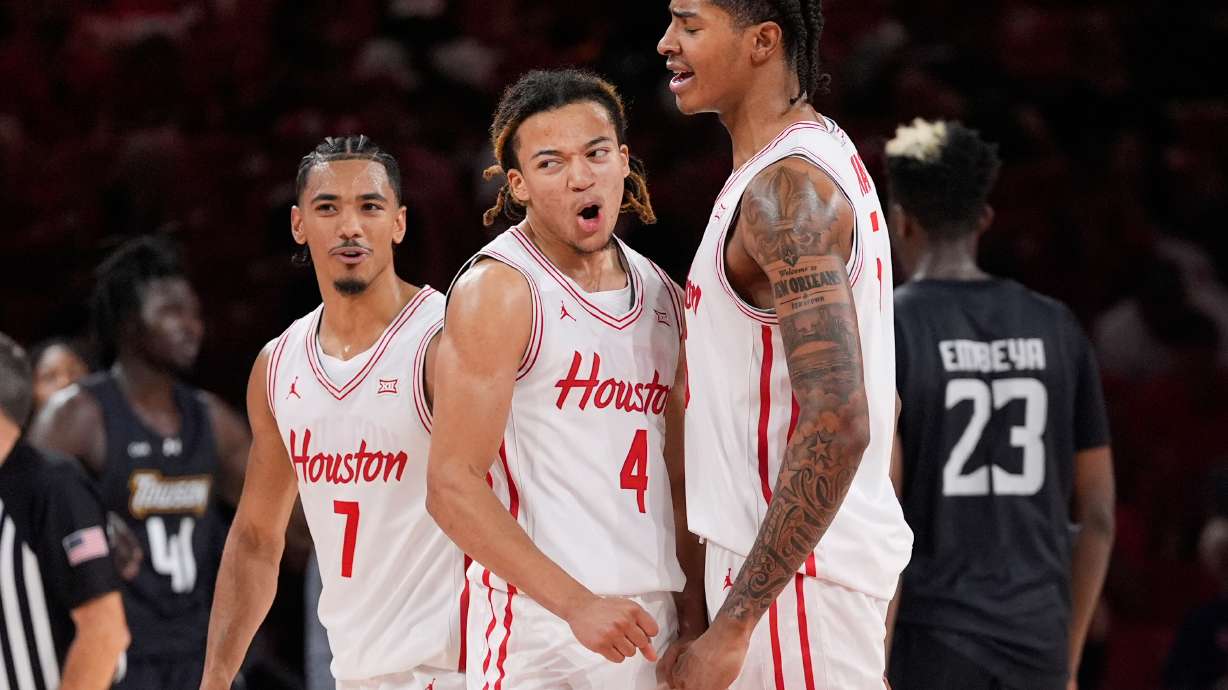 Houston guard Milos Uzan (7), guard Kingston Flemings (4) and center Chris Cenac Jr. (5) celebrate during the second half of an NCAA college basketball game against the Towson Tigers in Houston, Saturday, Nov. 8, 2025.