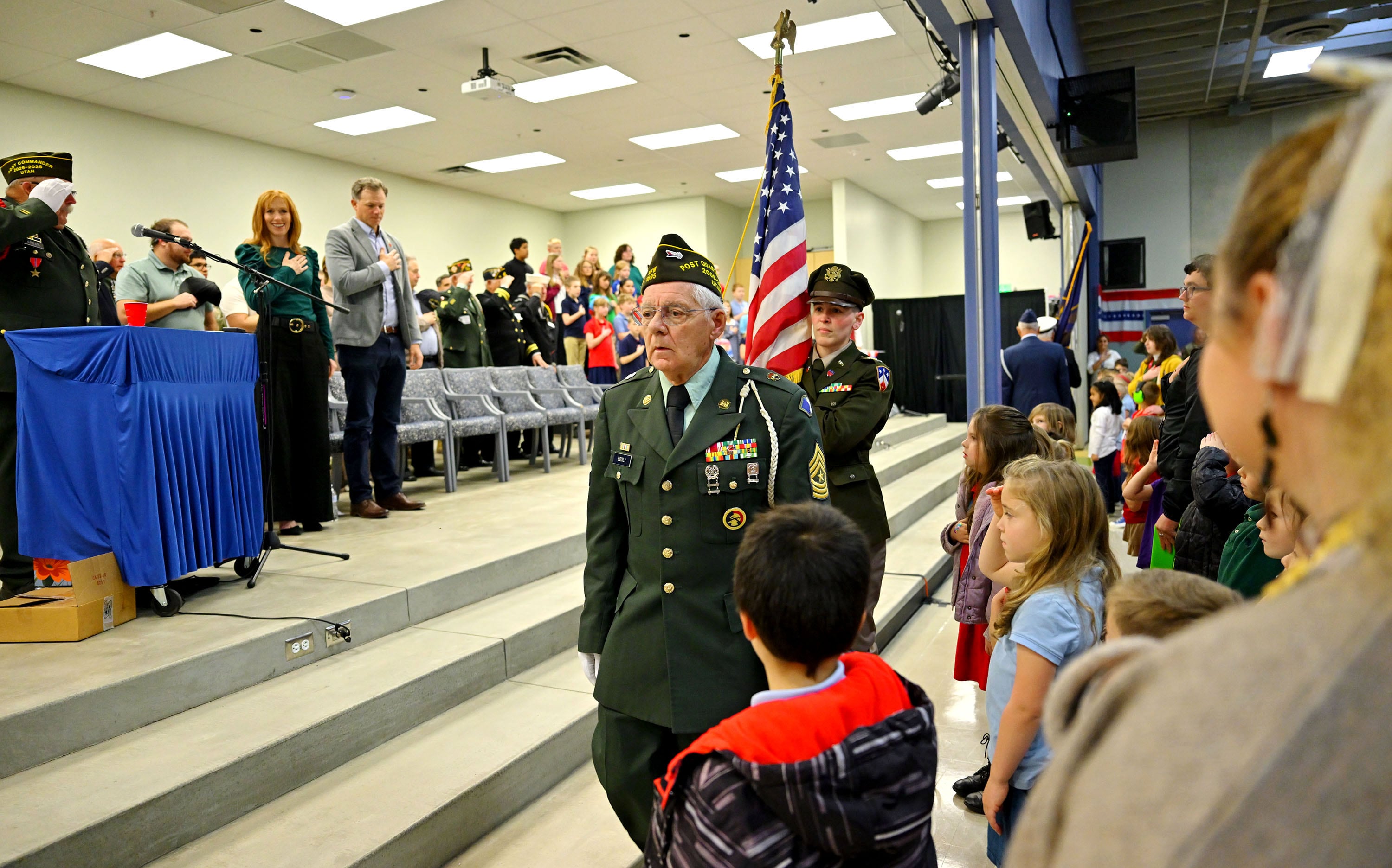 A color guard, Utah Rep. Blake Moore and Jennie Taylor join students at Promontory School of Expeditionary Learning to honor local service members at an assembly in Perry on Monday.