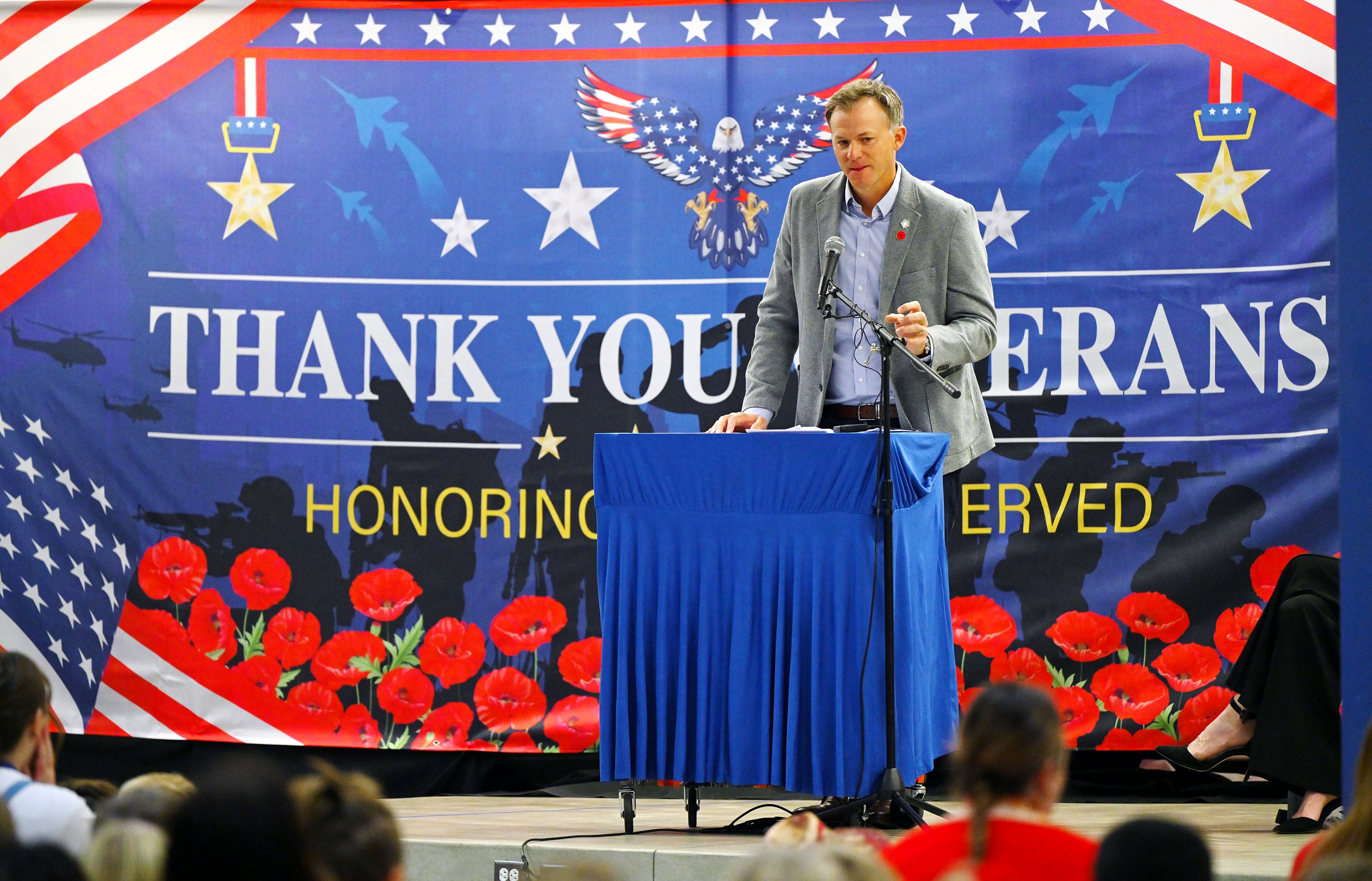 Utah Rep. Blake Moore speaks as he joins Jennie Taylor, the Gold Star widow of Utah Army National Guard Maj. Brent Taylor, who was killed in action in Afghanistan in November of 2018, and students at Promontory School of Expeditionary Learning to honor local service members at an assembly in Perry on Monday.