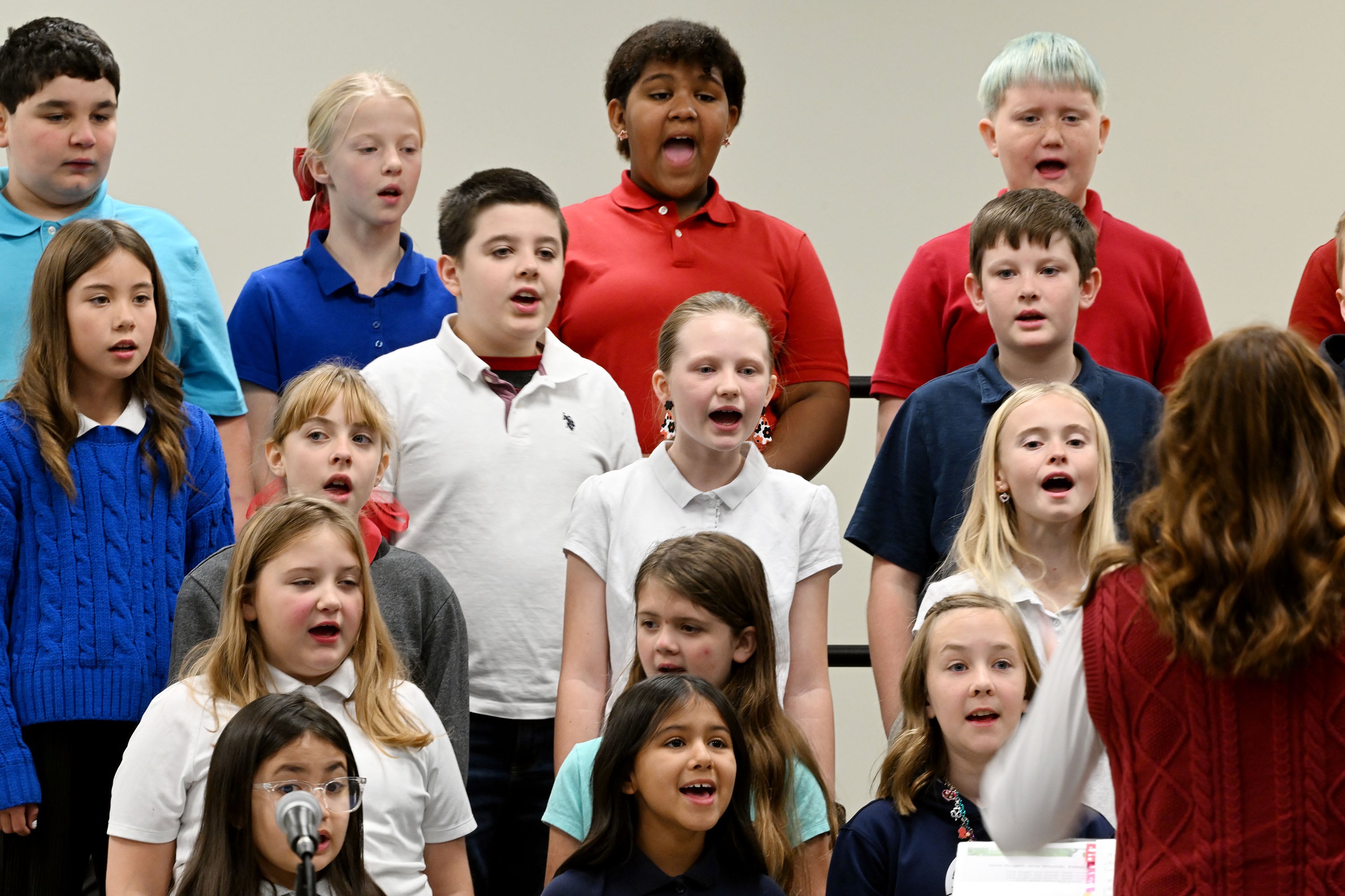 Members of the school choir sing while taking part in the program with Utah Rep. Blake Moore and Jennie Taylor, the Gold Star widow of Utah Army National Guard Maj. Brent Taylor, who was killed in action in Afghanistan in November of 2018, at Promontory School of Expeditionary Learning to honor local service members at an assembly in Perry on Monday.